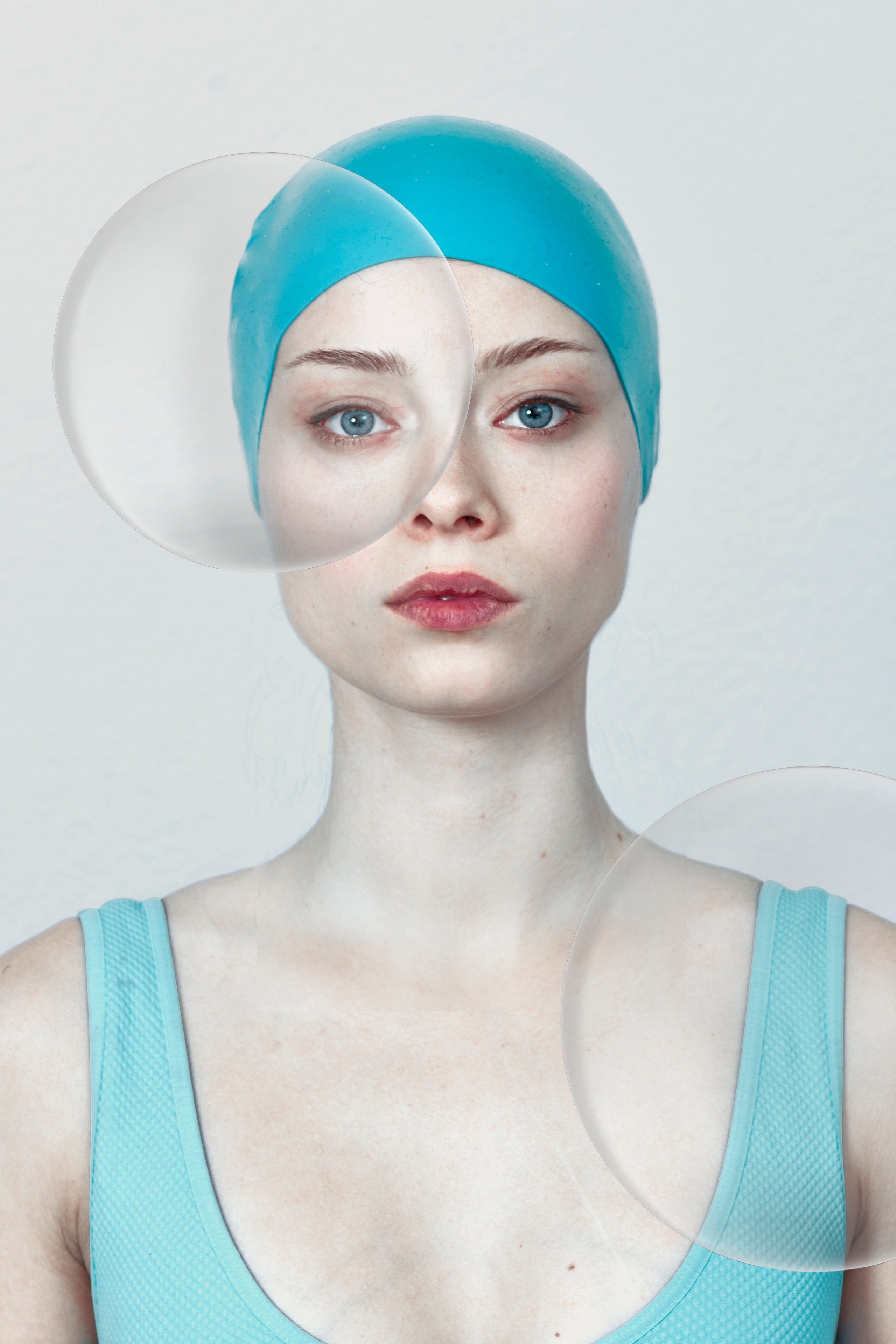Woman with swim cap and transparent bubbles, symbolizing vulnerability and adaptation