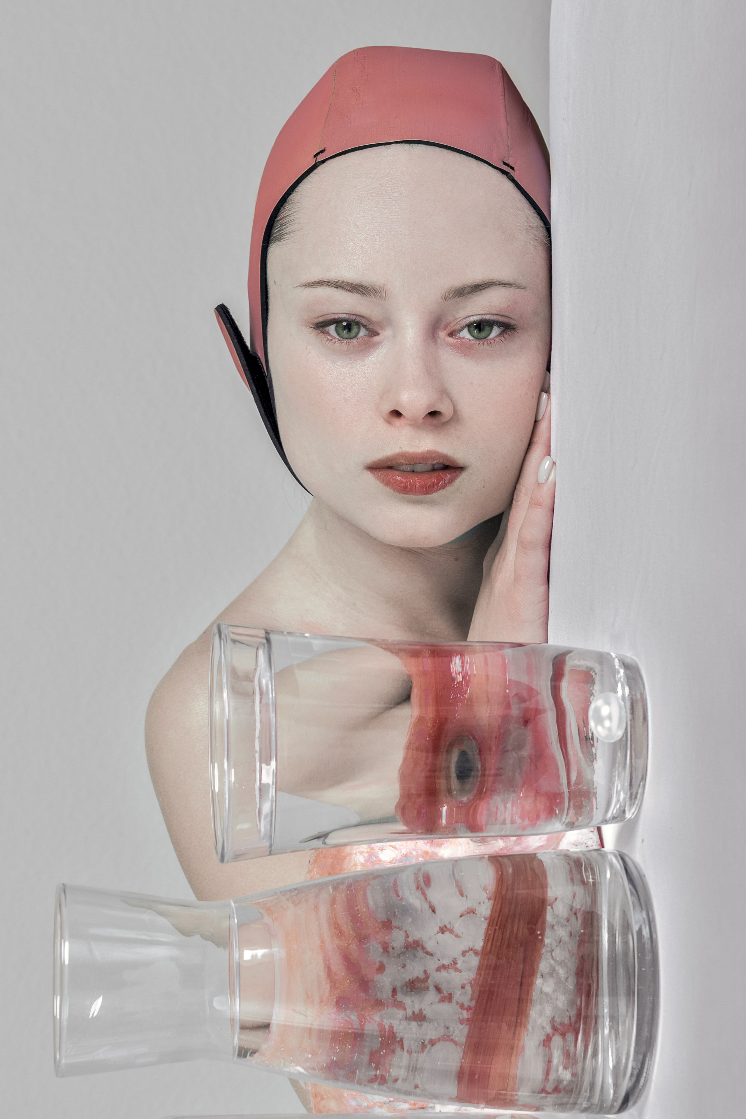 Woman partially hidden behind layered glass, evoking emotional and physical barriers