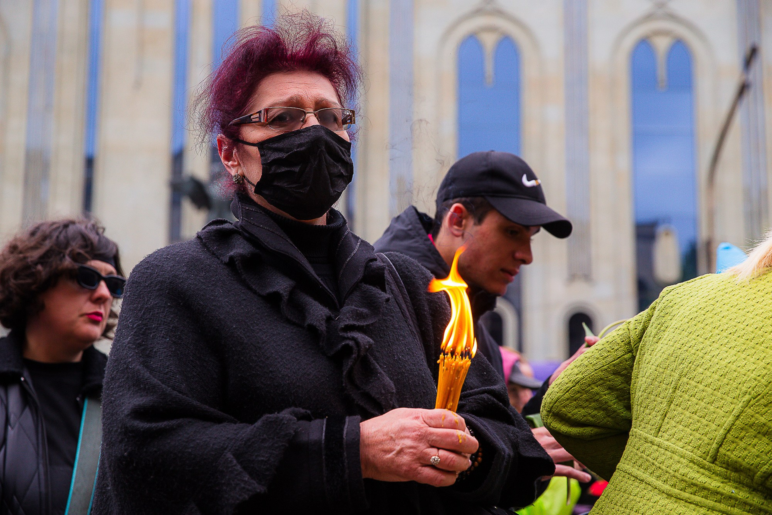 People with flowers and candles at April 9 memorial, Tbilisi 2025