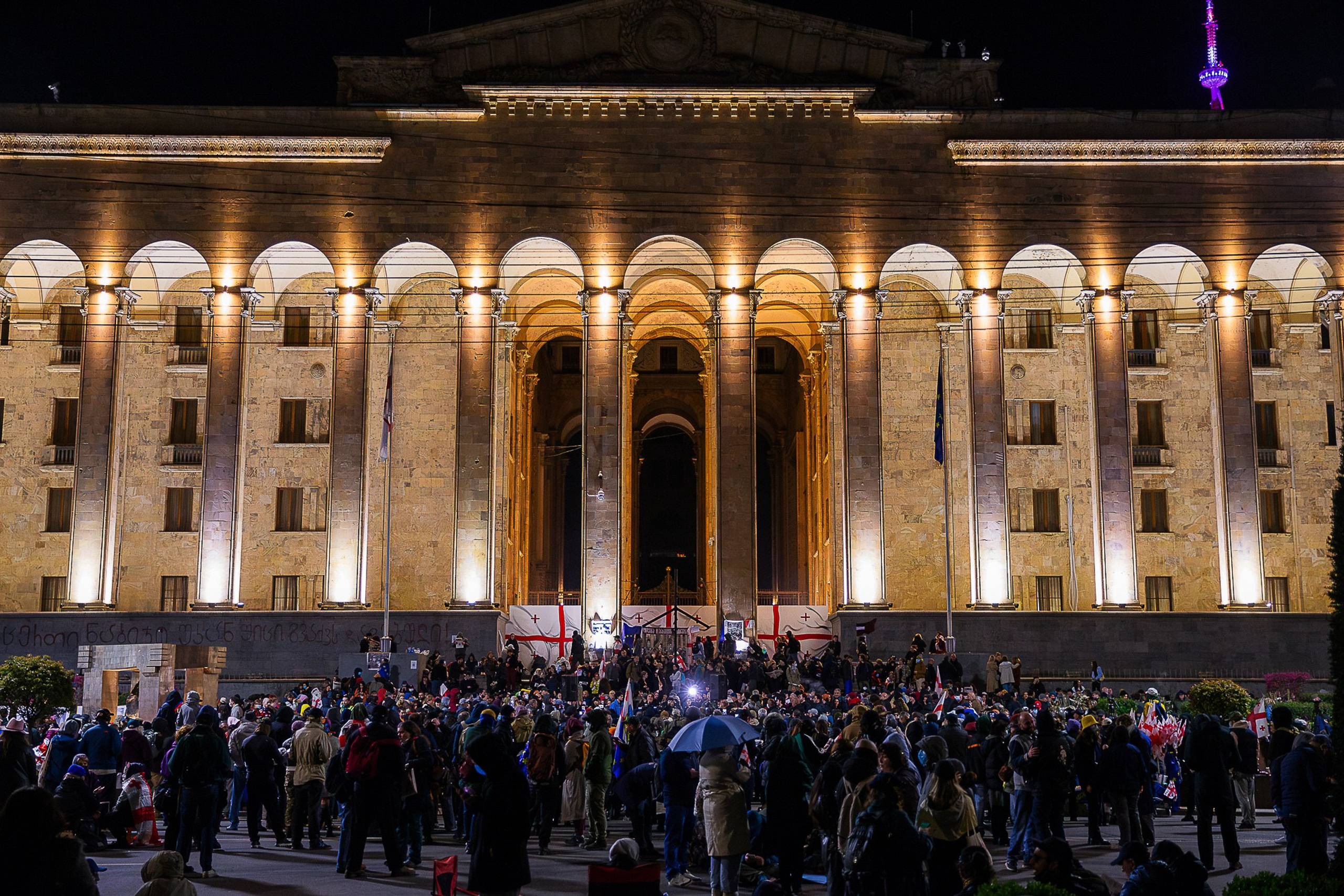 People with flowers and candles at April 9 memorial, Tbilisi 2025