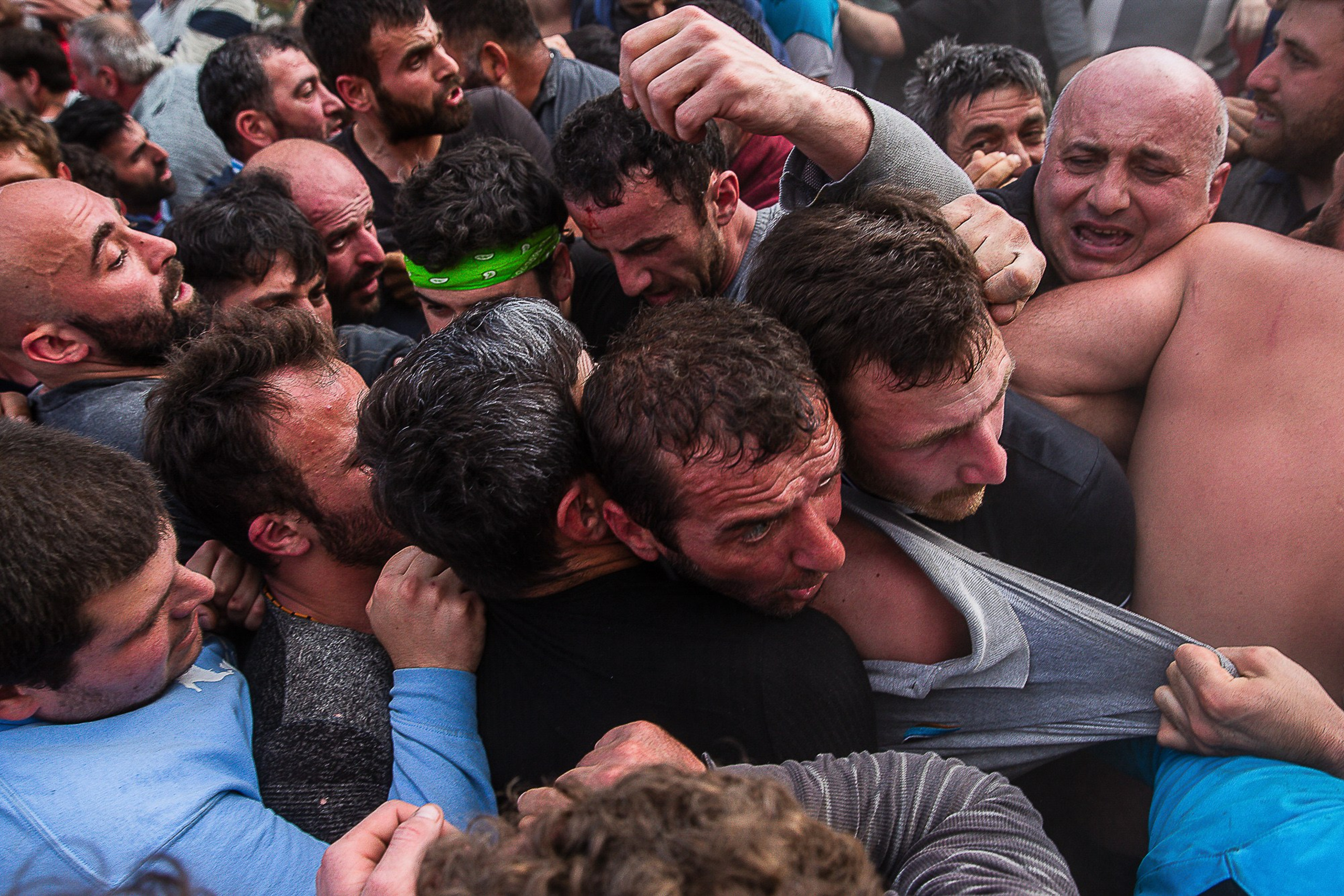 Lelo Burti participants pushing heavy ball on field, Georgia 2025