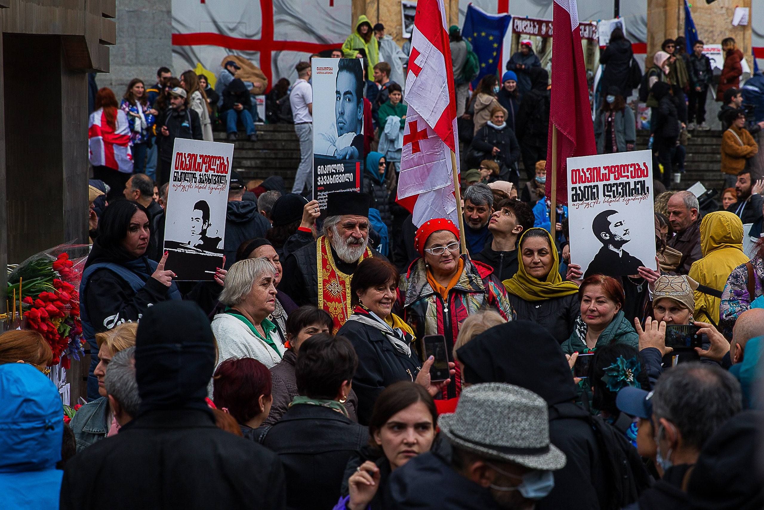 People with flowers and candles at April 9 memorial, Tbilisi 2025