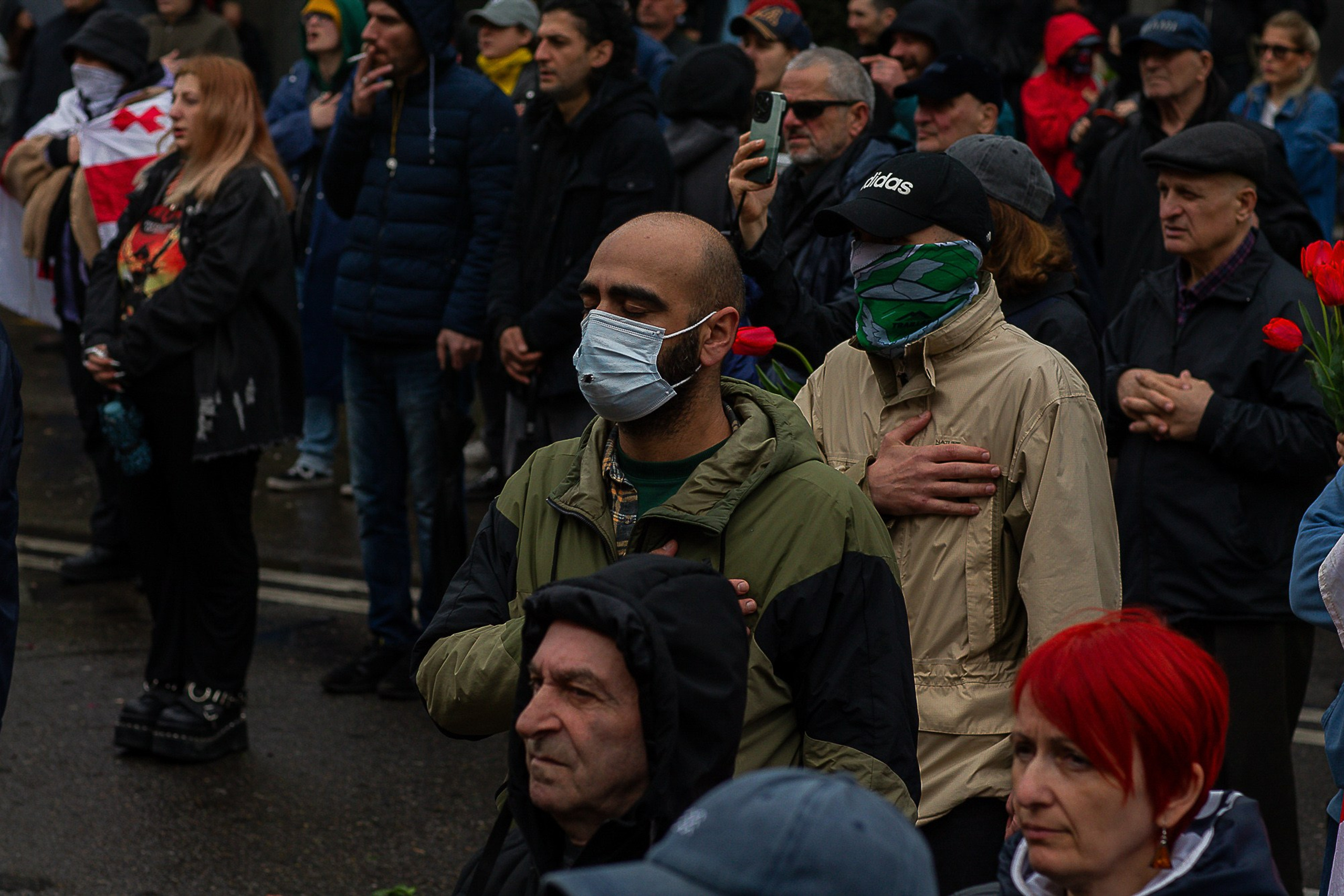 People with flowers and candles at April 9 memorial, Tbilisi 2025