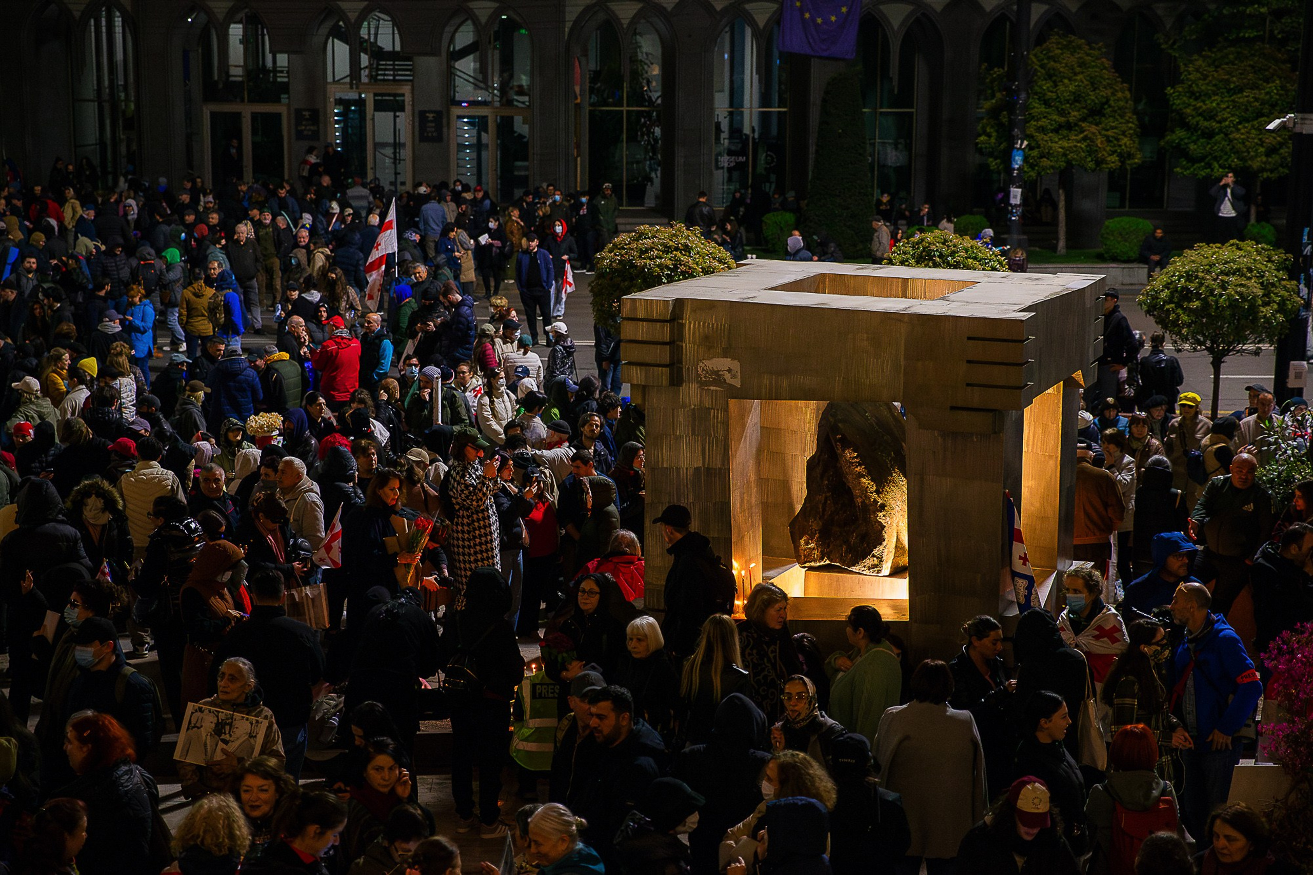 People with flowers and candles at April 9 memorial, Tbilisi 2025