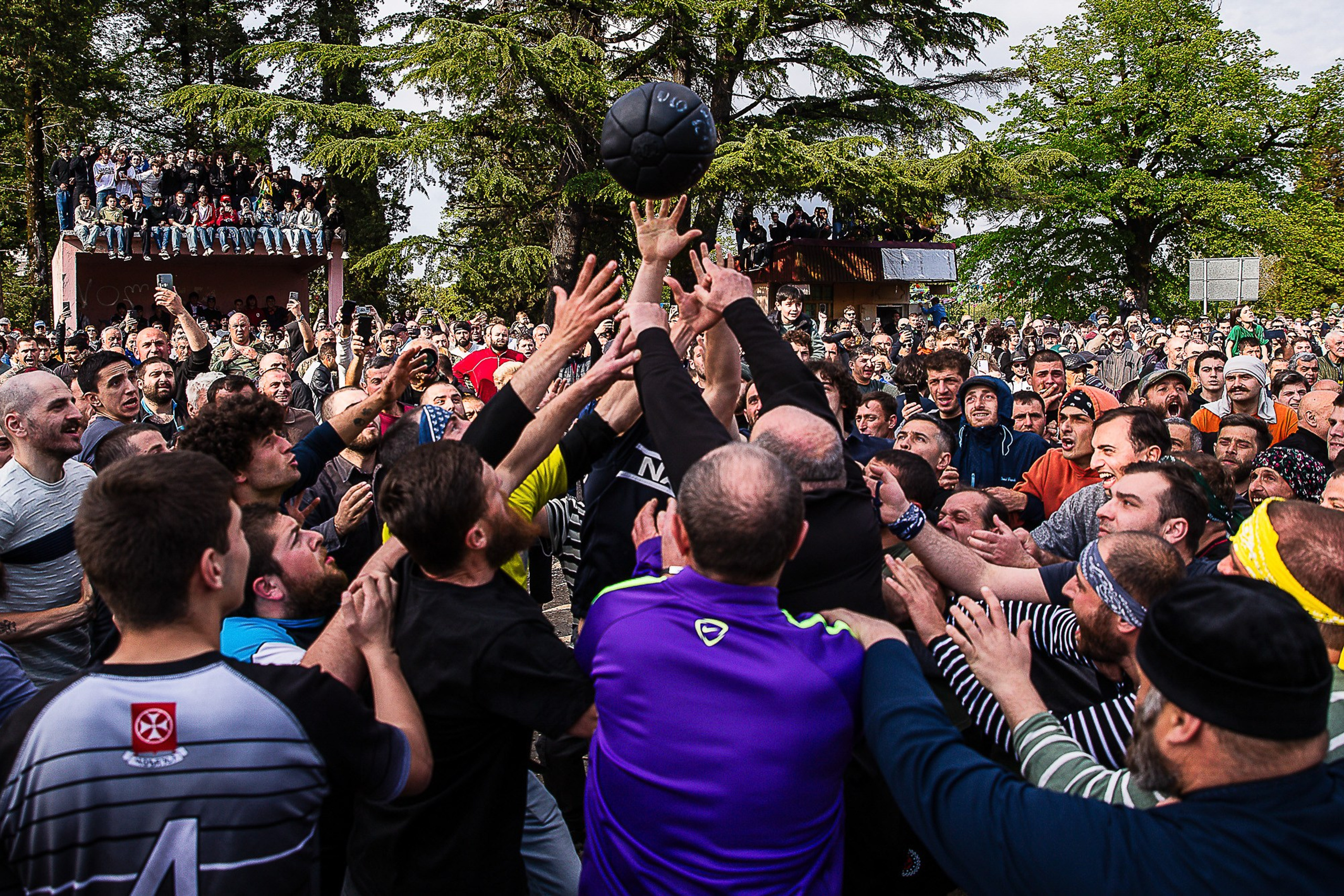 Lelo Burti players dragging heavy leather ball, Shukhuti, Georgia 2025