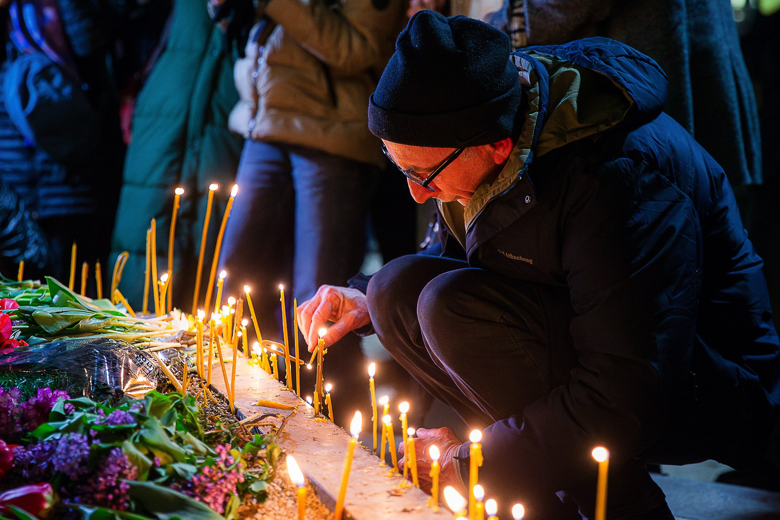 People with flowers and candles at April 9 memorial, Tbilisi 2025