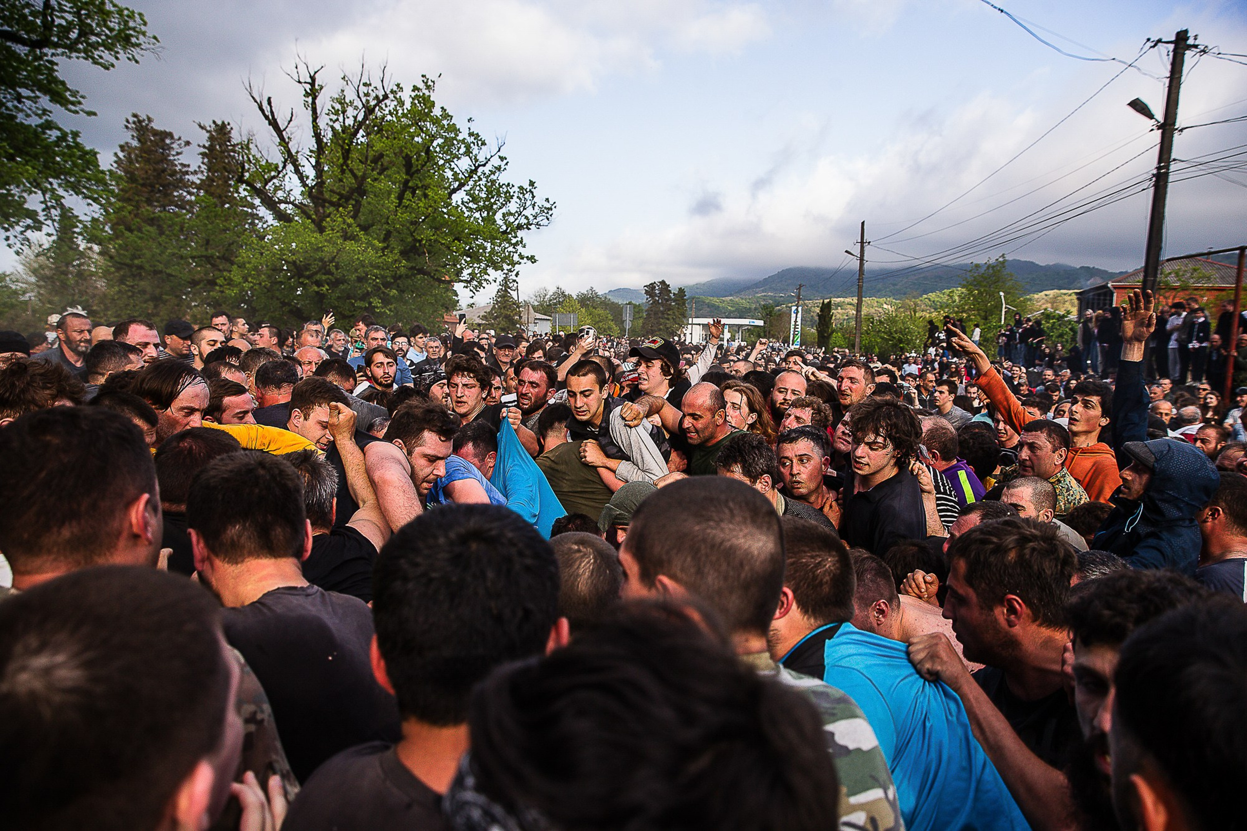 Village team dragging heavy leather ball with mountains, Lelo Burti 2025