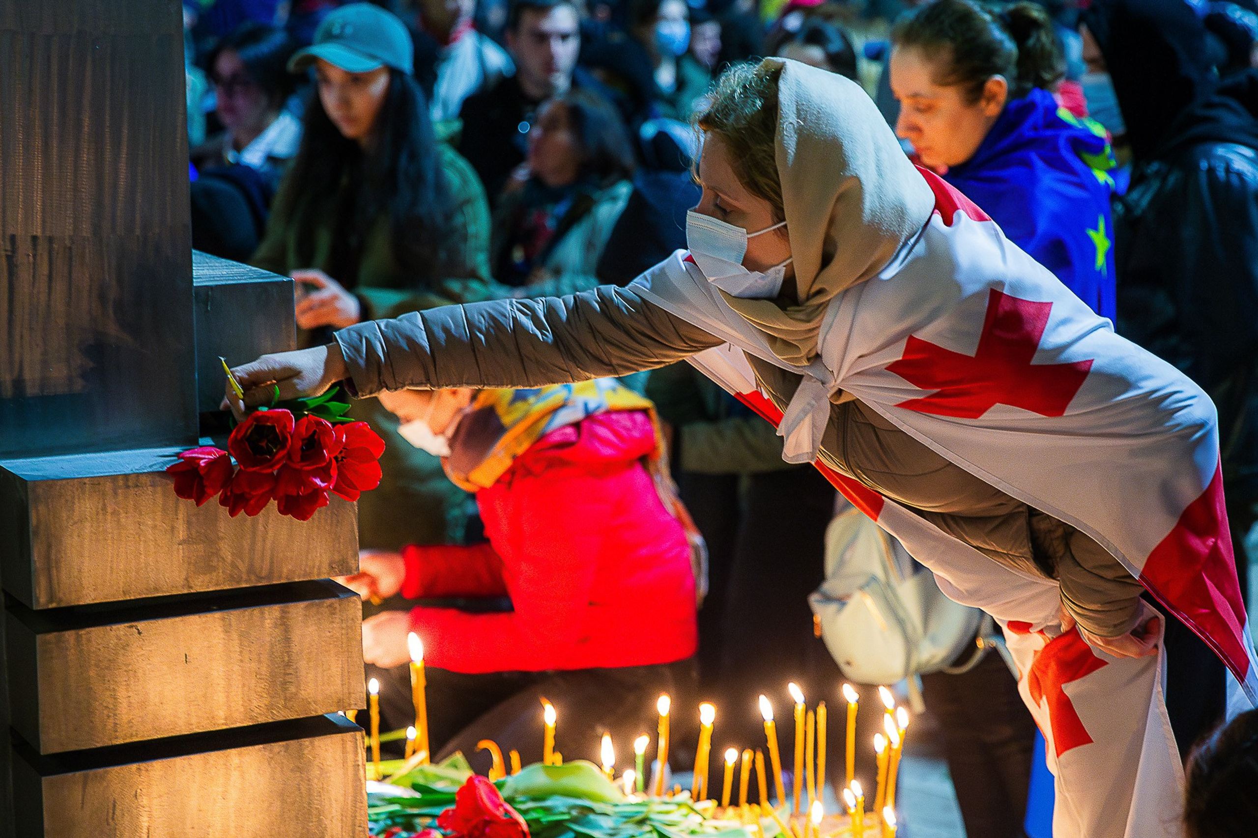 People with flowers and candles at April 9 memorial, Tbilisi 2025