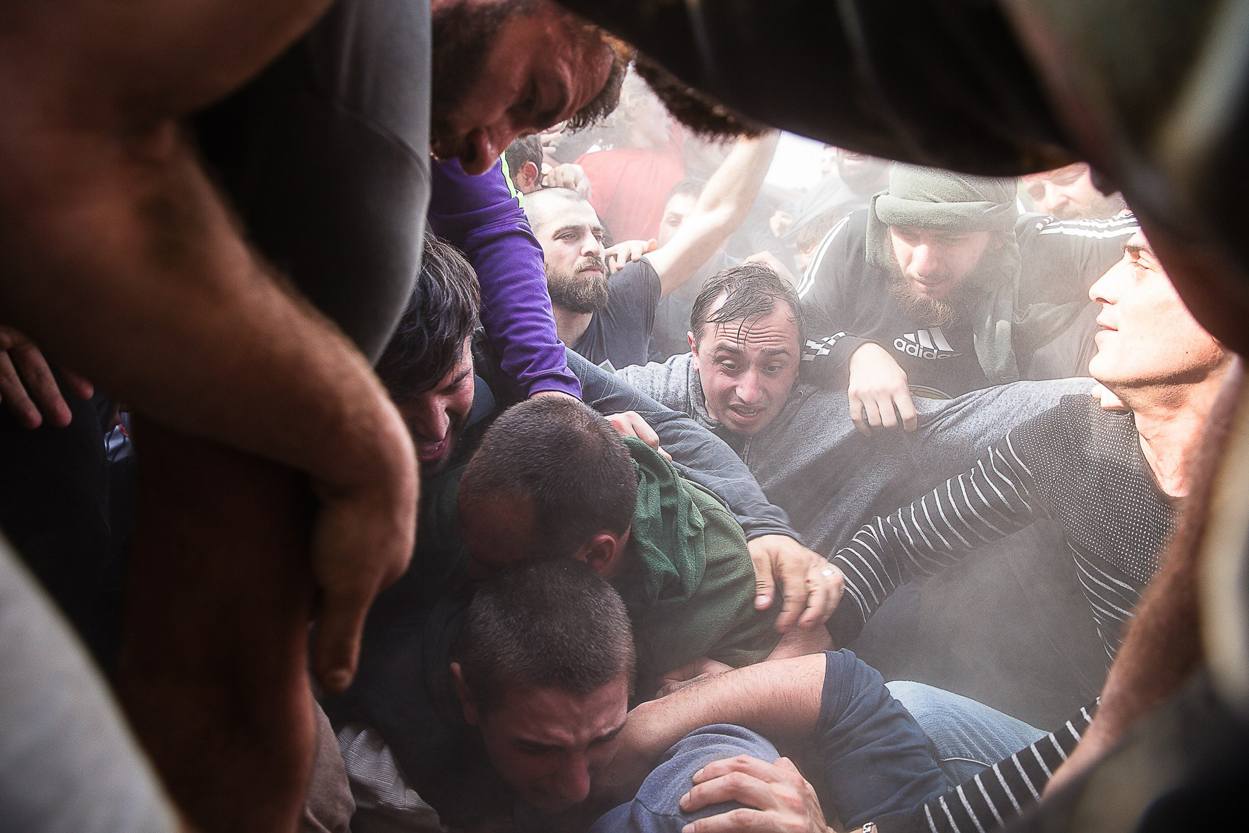 Lelo Burti participants pushing heavy ball on field, Georgia 2025