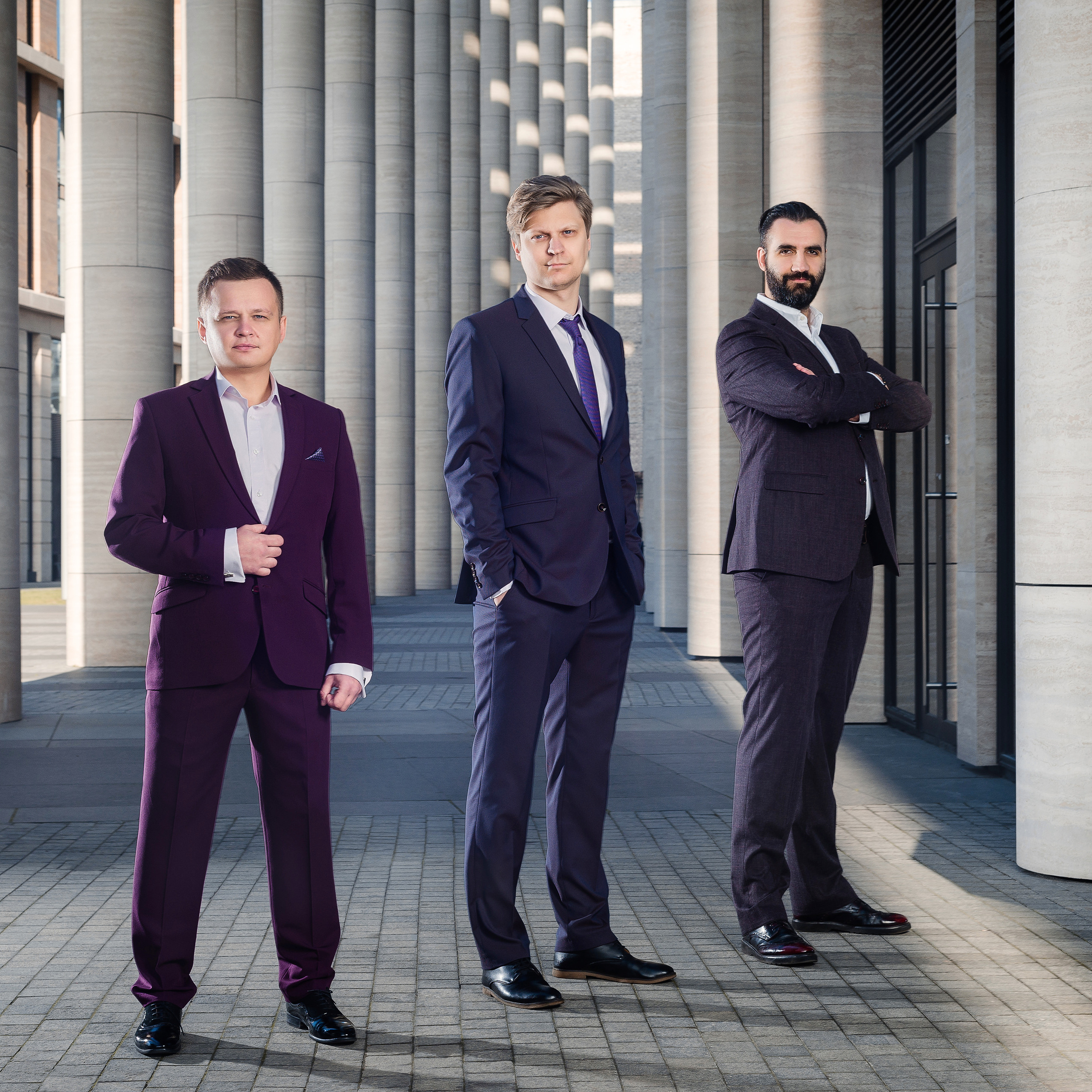 Team of business professionals in formal attire standing confidently by Dmitrii Shmatov, suitable for corporate branding.