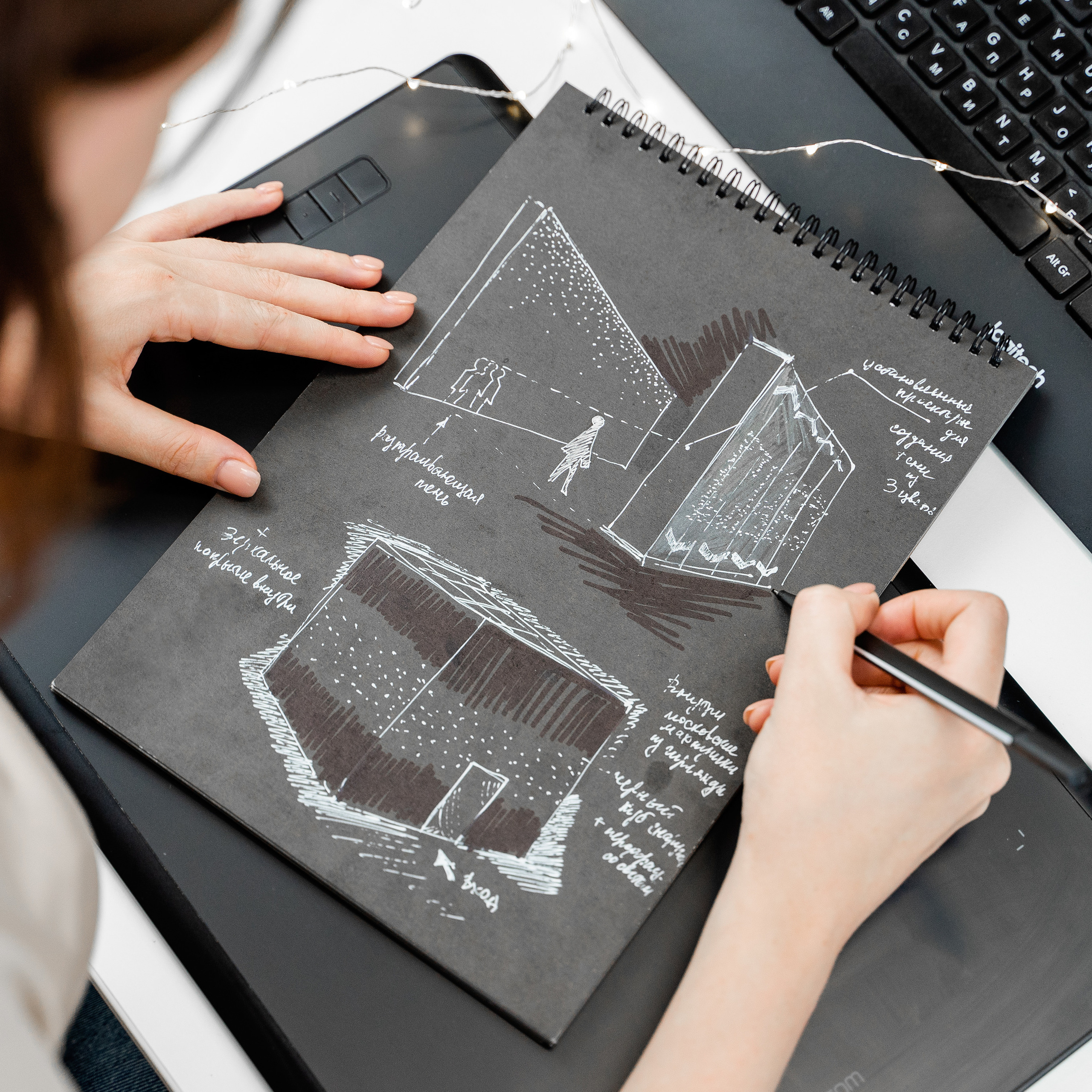 Focused professional sketching architectural designs, highlighting planning and strategy in business, photographed by Dmitrii Shmatov.