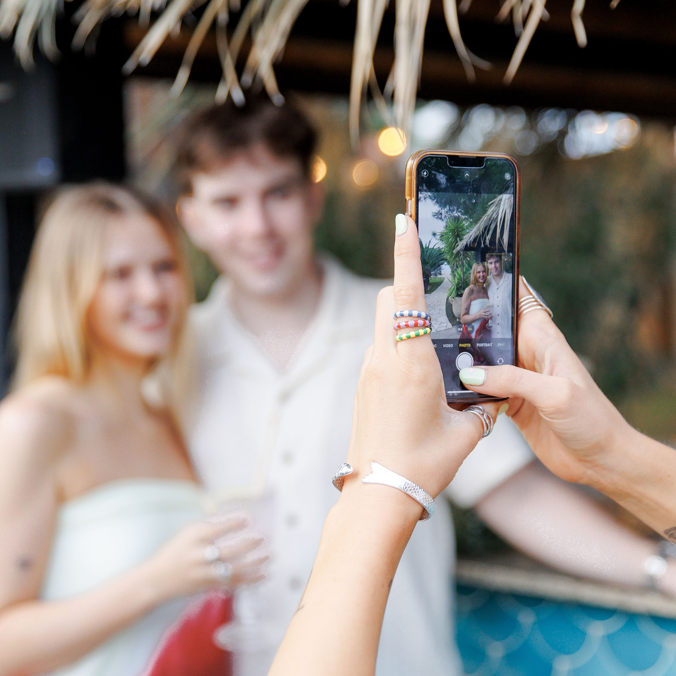 Candid moment of friends reuniting at a destination wedding rehearsal party in Spain