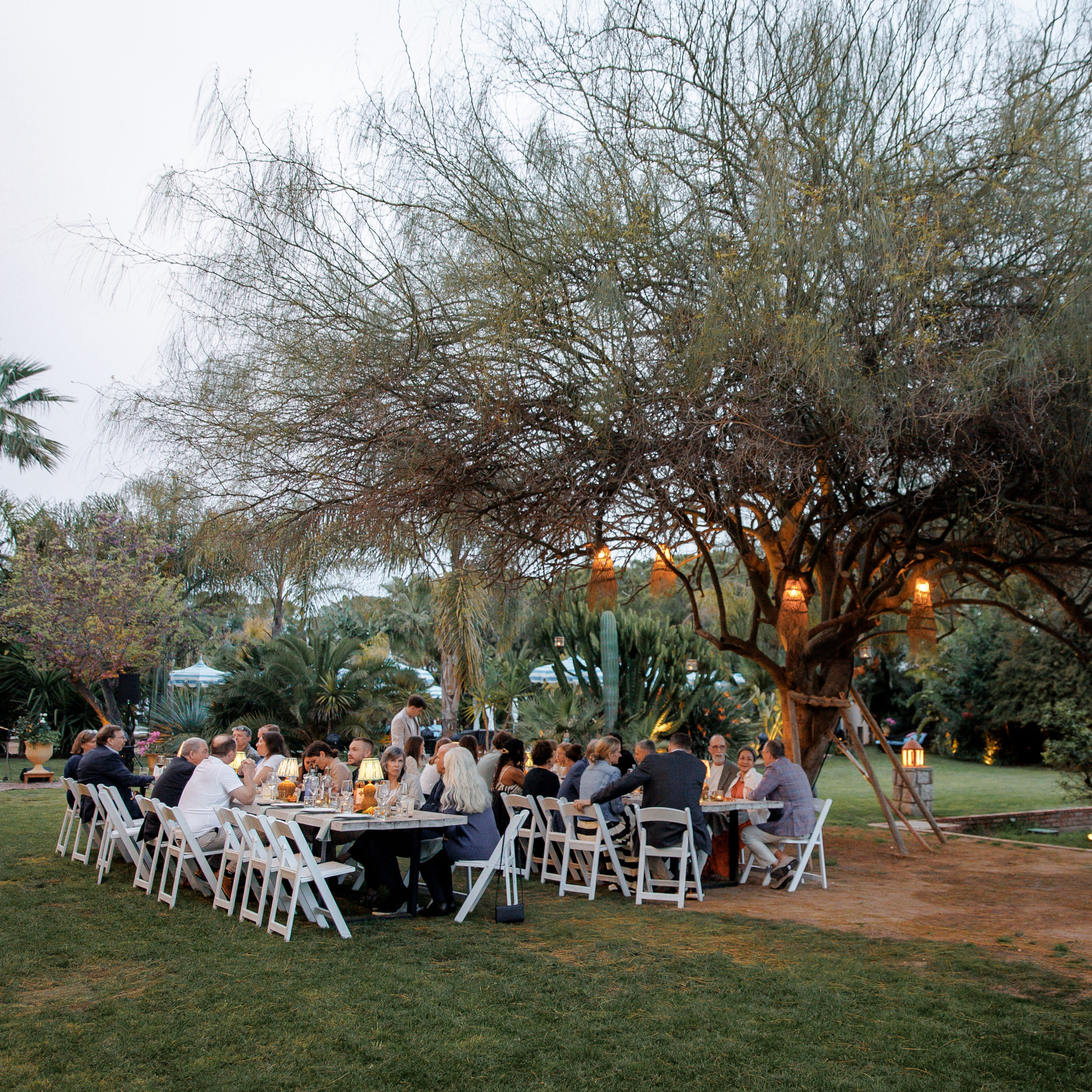 Romantic outdoor rehearsal dinner setup under string lights in Barcelona