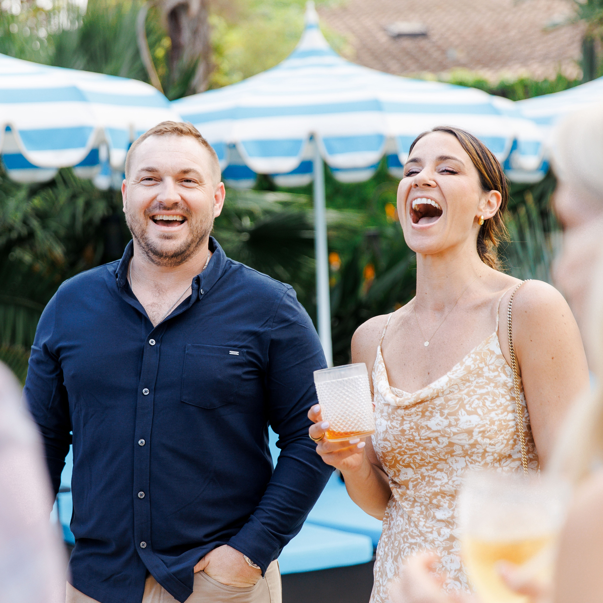 Guests sharing laughter during rehearsal dinner at Gran Villa Rosa, Barcelona