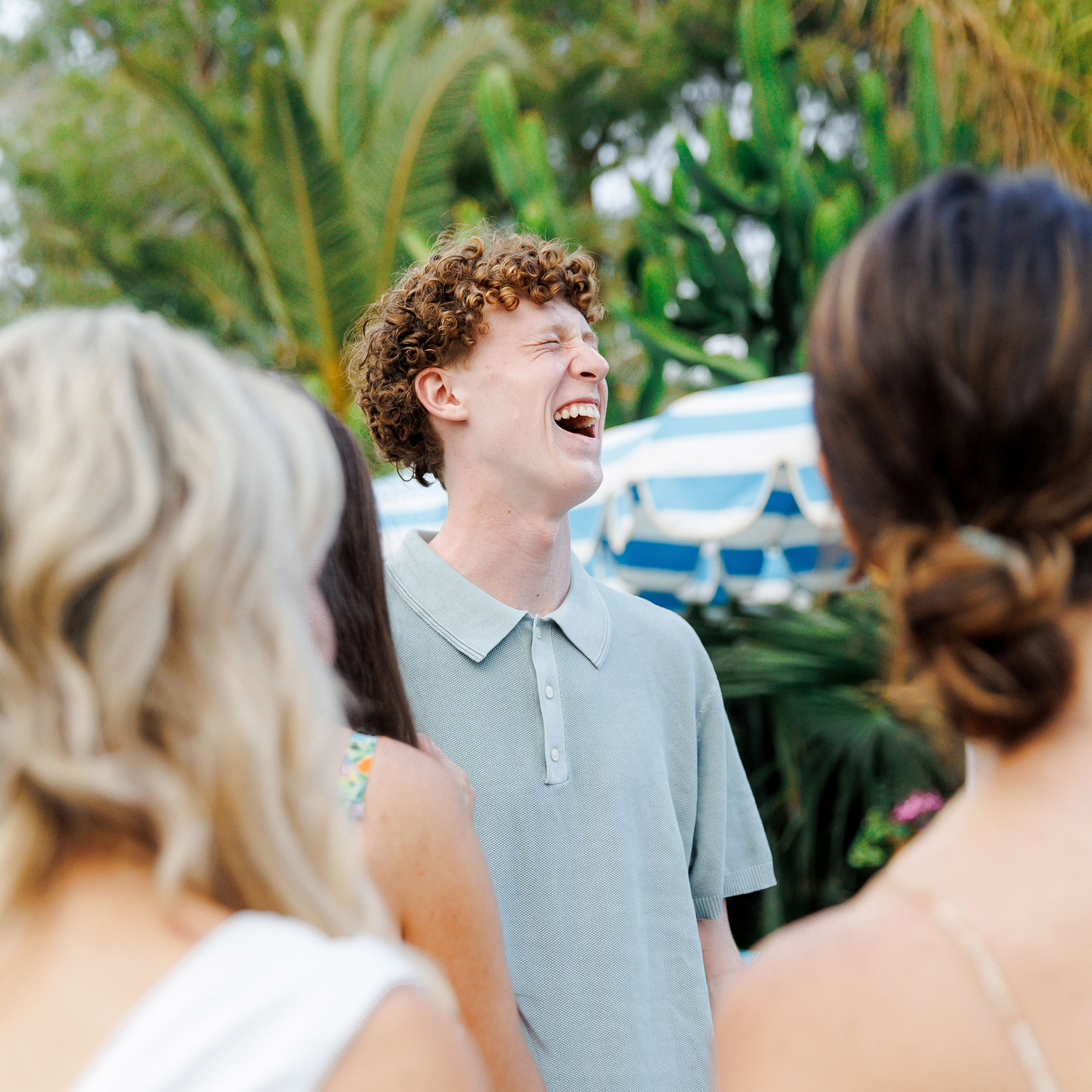 Guests sharing a laugh with friends at rehearsal dinner in Spain