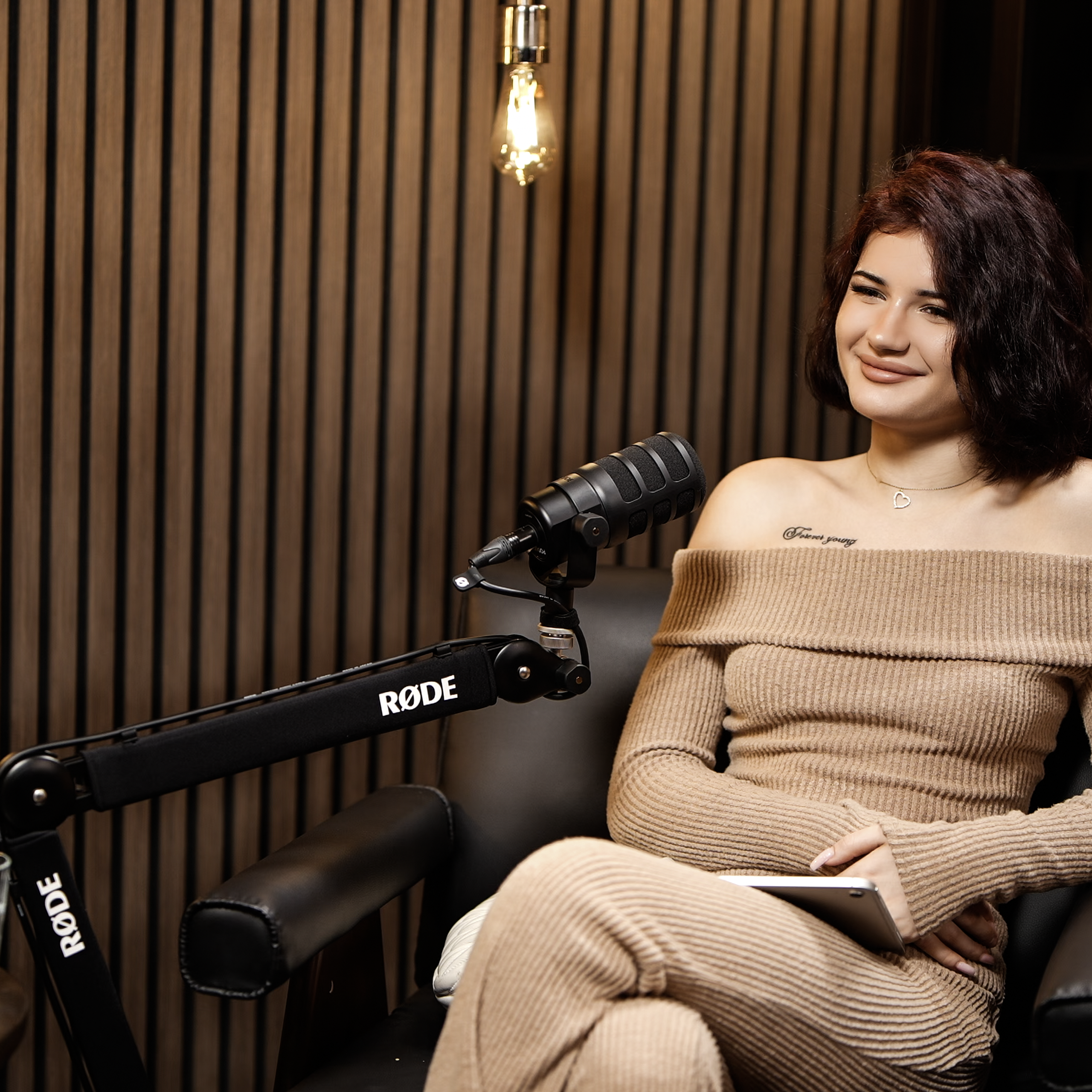 Cinematic interview scene in Zone 2 at ProStudio1 Hollywood, Florida — a premium lounge set for YouTube podcasts and social media clips near Miami.