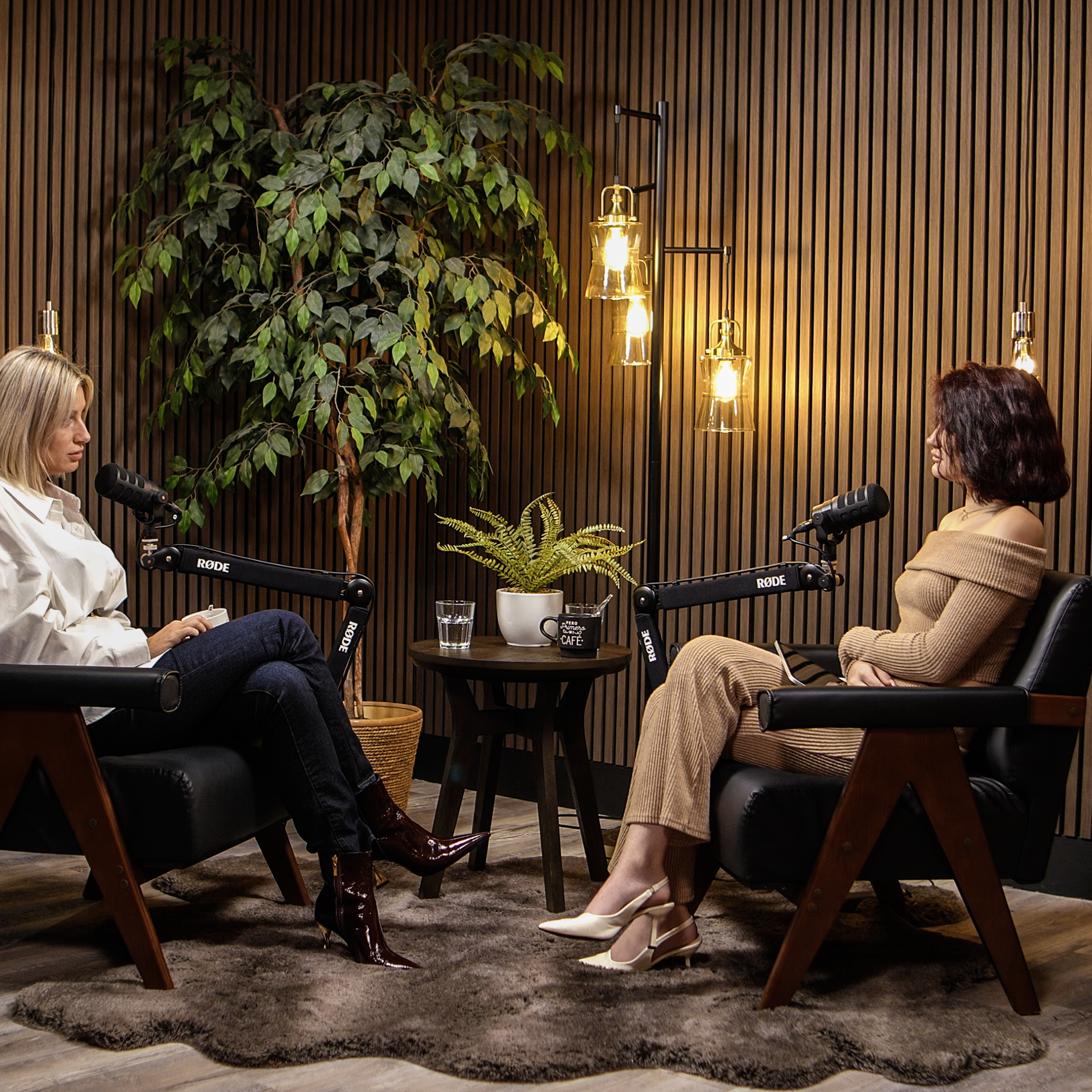 Conversation scene in Zone 2 Cinematic Lounge at ProStudio1 near Miami — a cozy, cinematic studio set for interviews and YouTube podcasts in Hollywood, FL.
