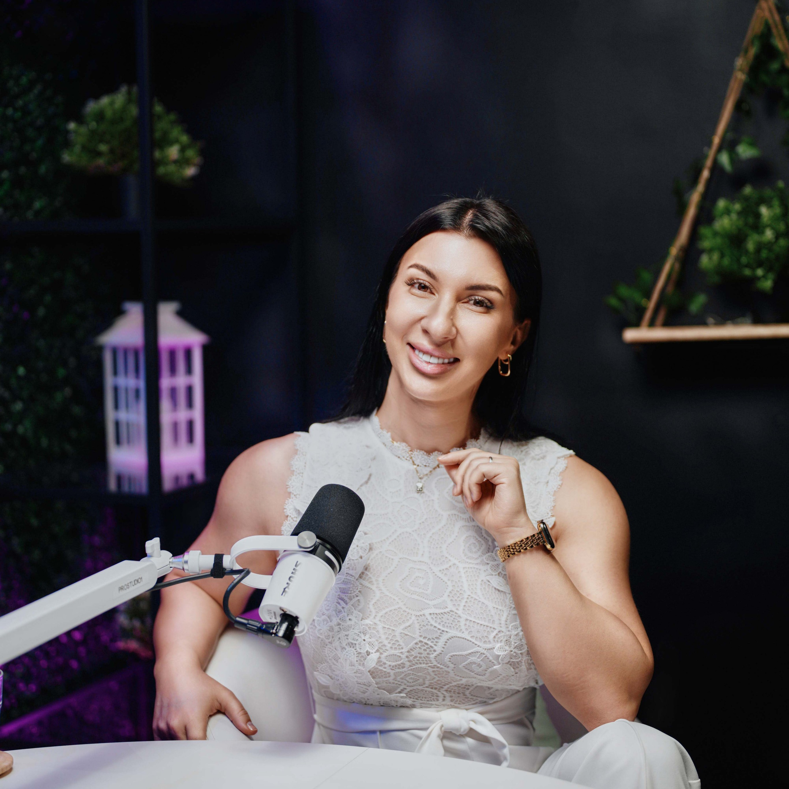 Podcast close-up shot at ProStudio1, Hollywood FL — speaker on mic at round-table set with dark cinematic background.