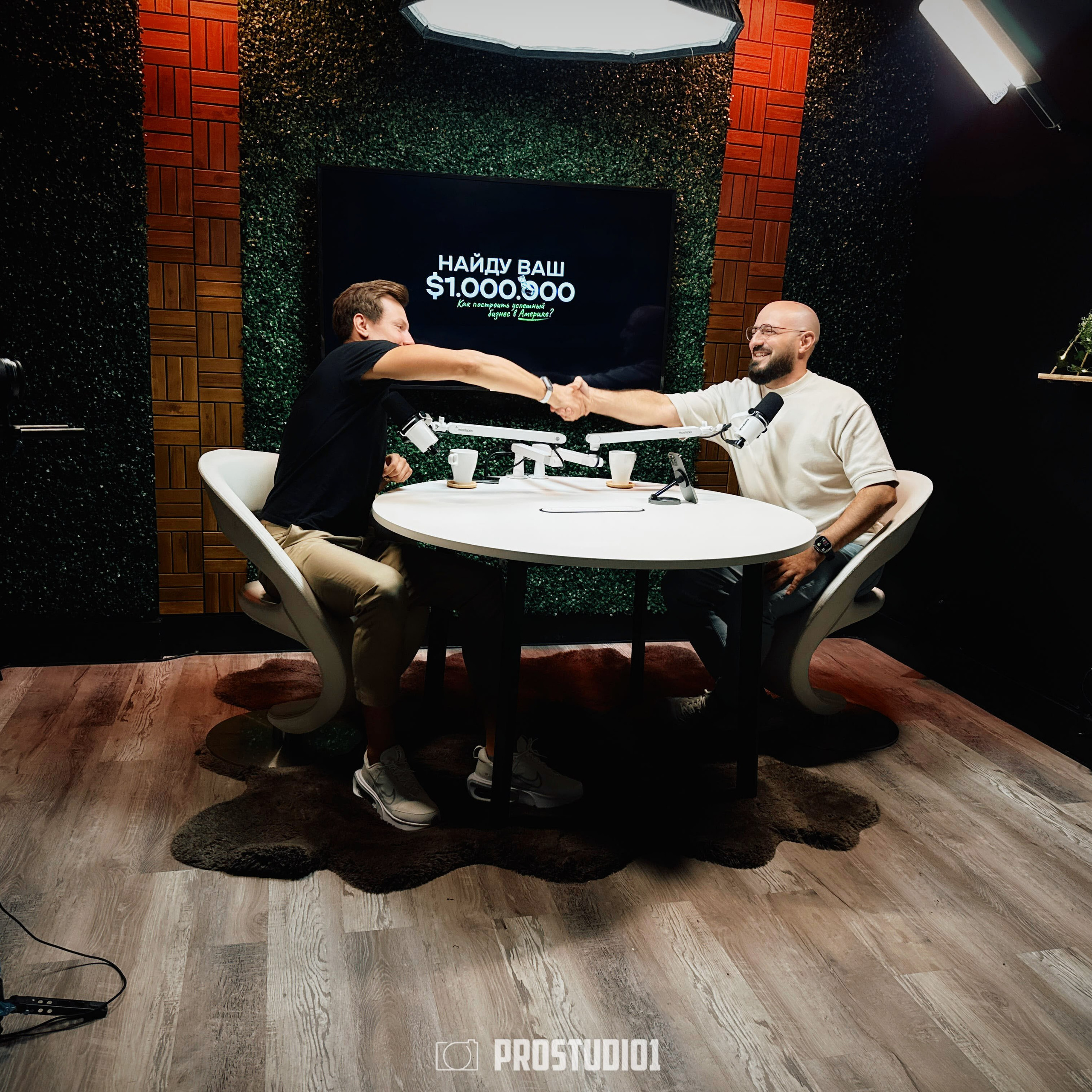 Podcast round-table scene at ProStudio1 in Hollywood, FL — wide angle of two guests with microphones and studio lighting on the talk-show set.