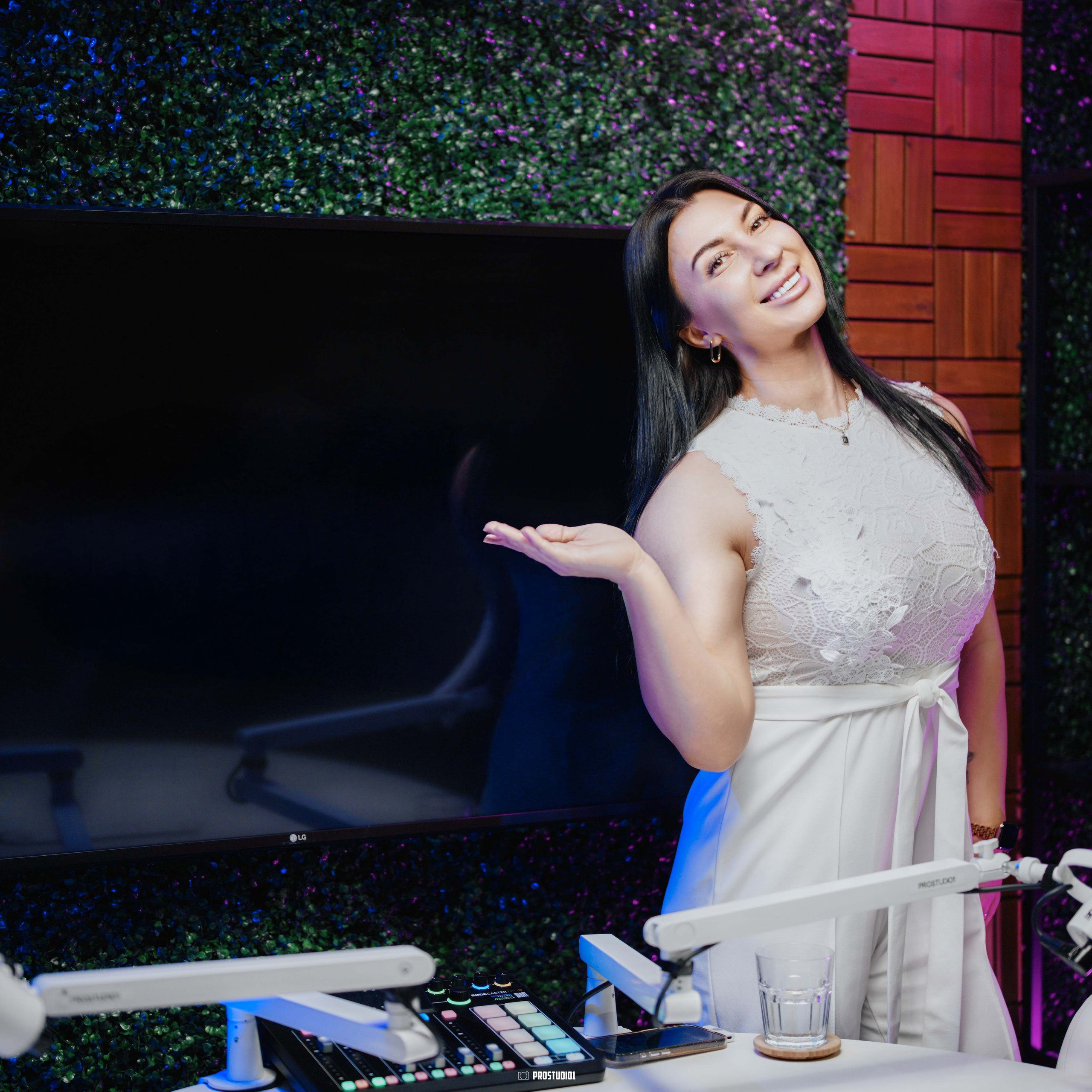 Talk-show set angle view at ProStudio1 in Hollywood, Florida — interview table, studio mic arms, and cinematic accent lights.