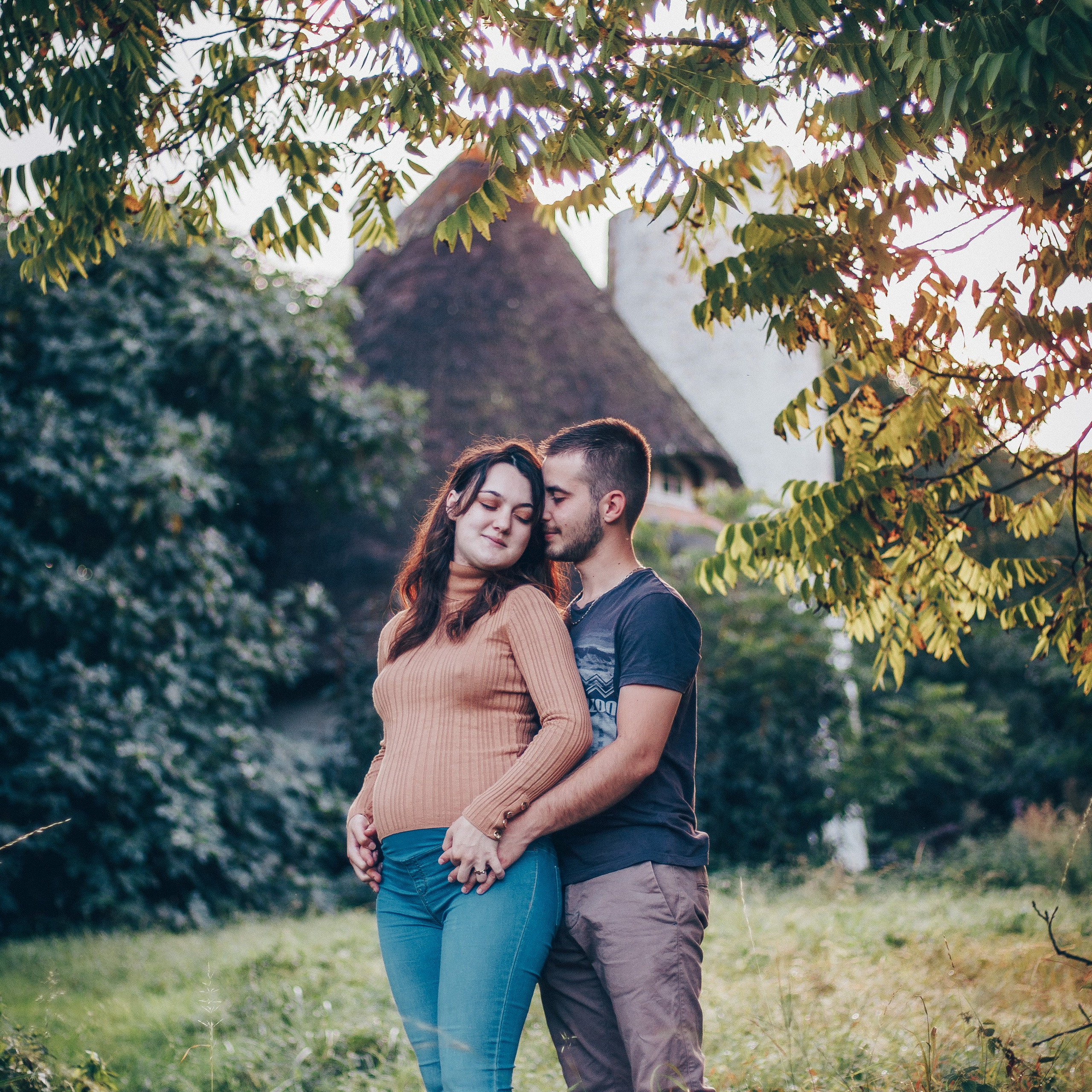 Photo de grossesse dans un jardin – un couple attend son enfant avec amour