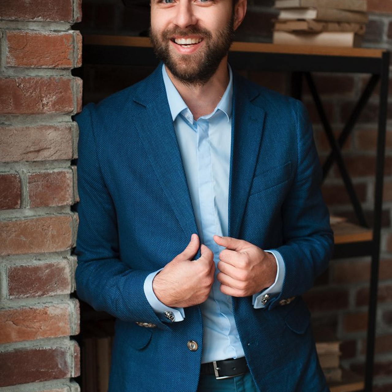 Professional headshot of a confident businessman in a blue suit by Dmitrii Shmatov, ideal for corporate branding.