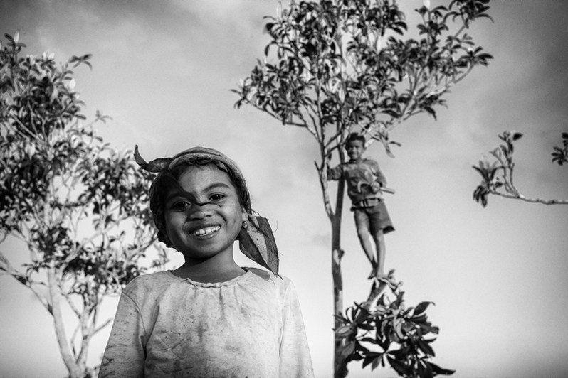 Portrait of children playing with the trees in the garden, Sahambavy, Lalangina district, Haute Matsiatra region, Fianarantsoa province, Republic of Madagascar. 2016