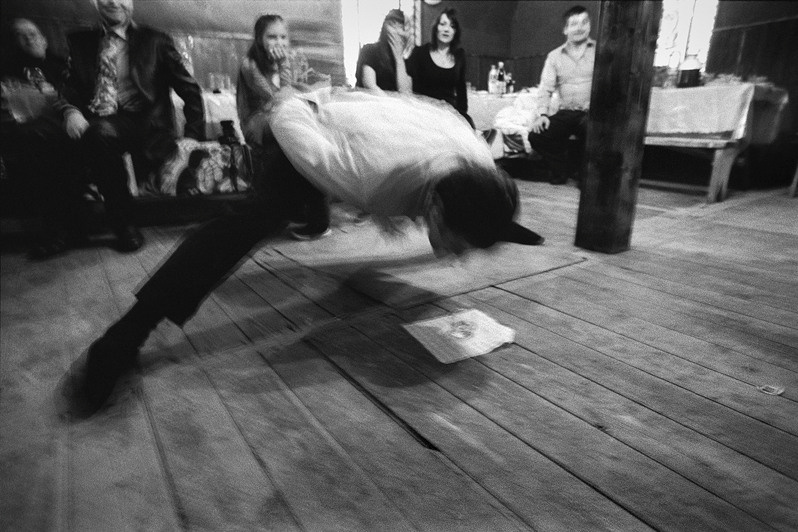 A glass of vodka on the floor without hands, Senshin khutor, Oblivsky district, Rostov-on-Don region, Russia. February 2012