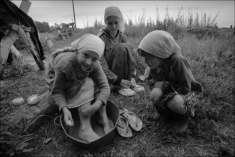 "Girls wash their feet after working in the garden", village of Poteryaevka, Mamontovo district, Altai territory, Russia, July 2008