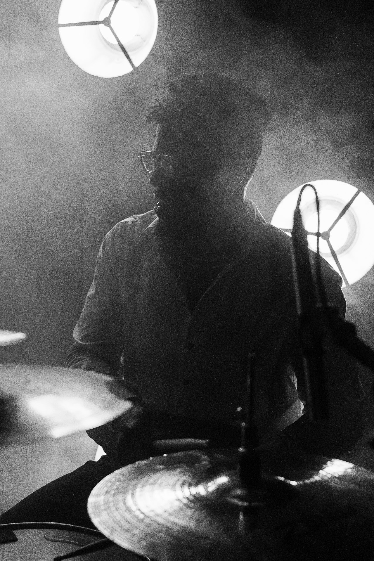 Close-up of a professional drummer performing live at a corporate event show in Milan.