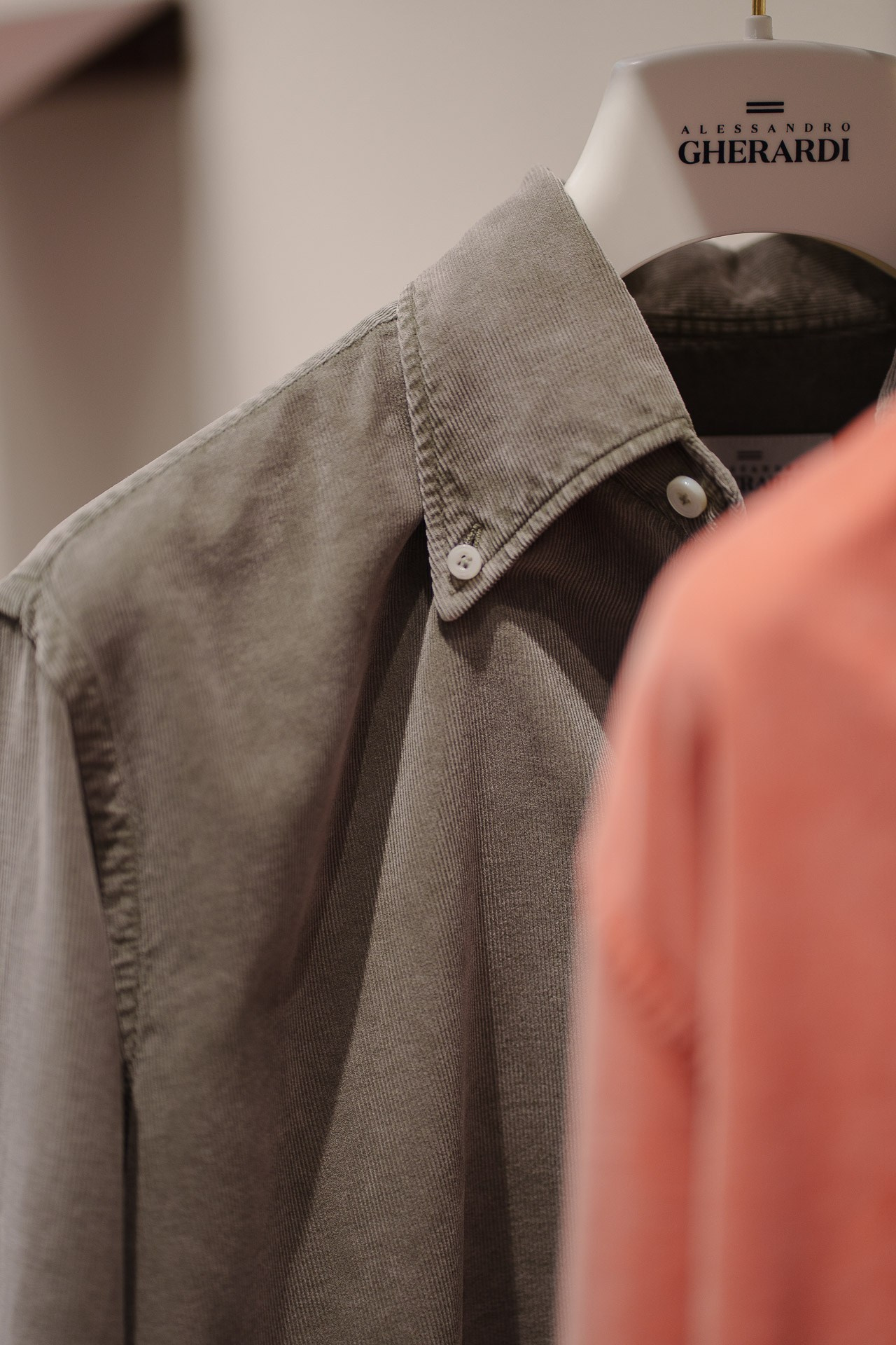 Close-up of a unique floral print shirt on a branded Alessandro Gherardi hanger.