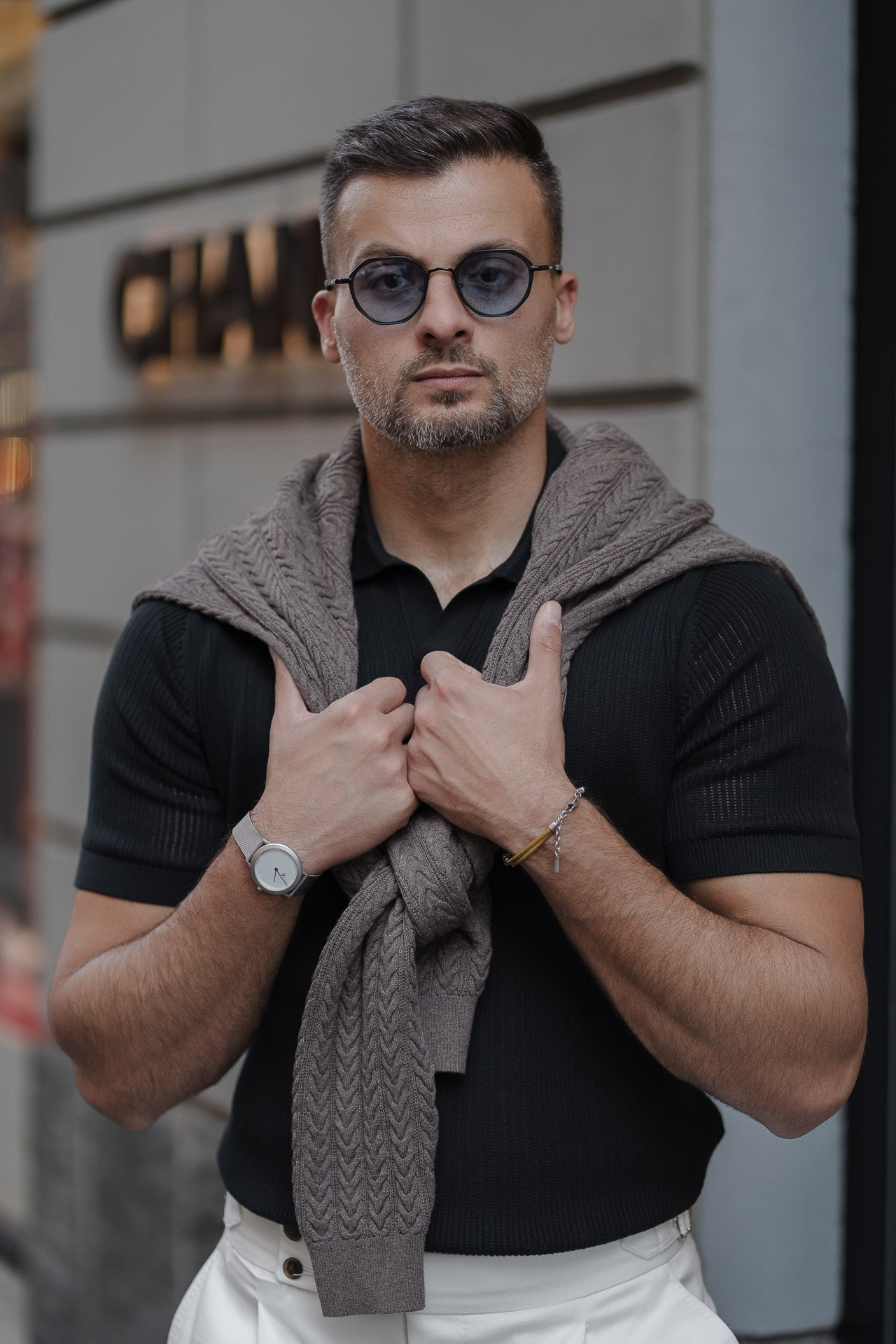 Close-up male portrait of Jamal wearing sunglasses in central Milan