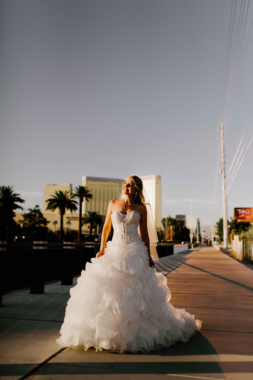 Bride on a city street in the rays of the outgoing day.