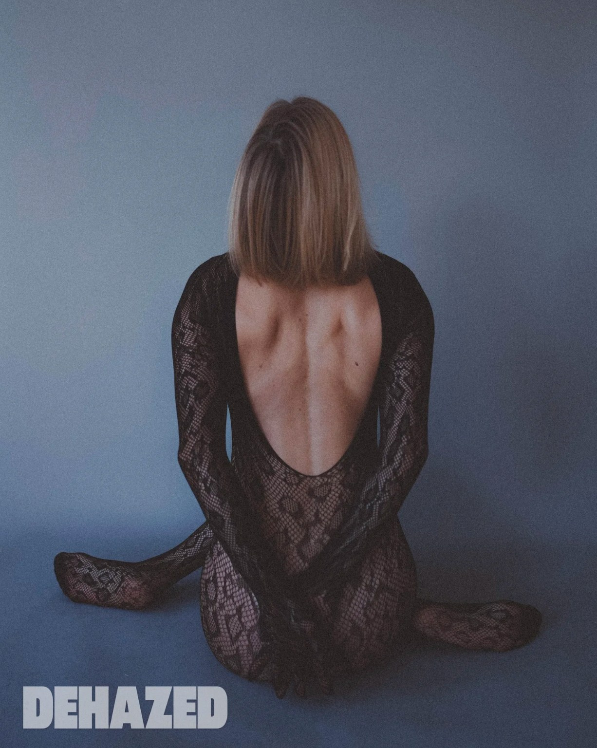 Fine art boudoir photograph of a seated woman in sheer fabric, editorial boudoir photographer West Midlands