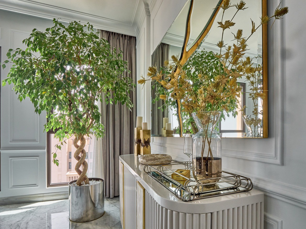 Elegant hallway with mirror and floral decor, interior photography for boutique rentals.