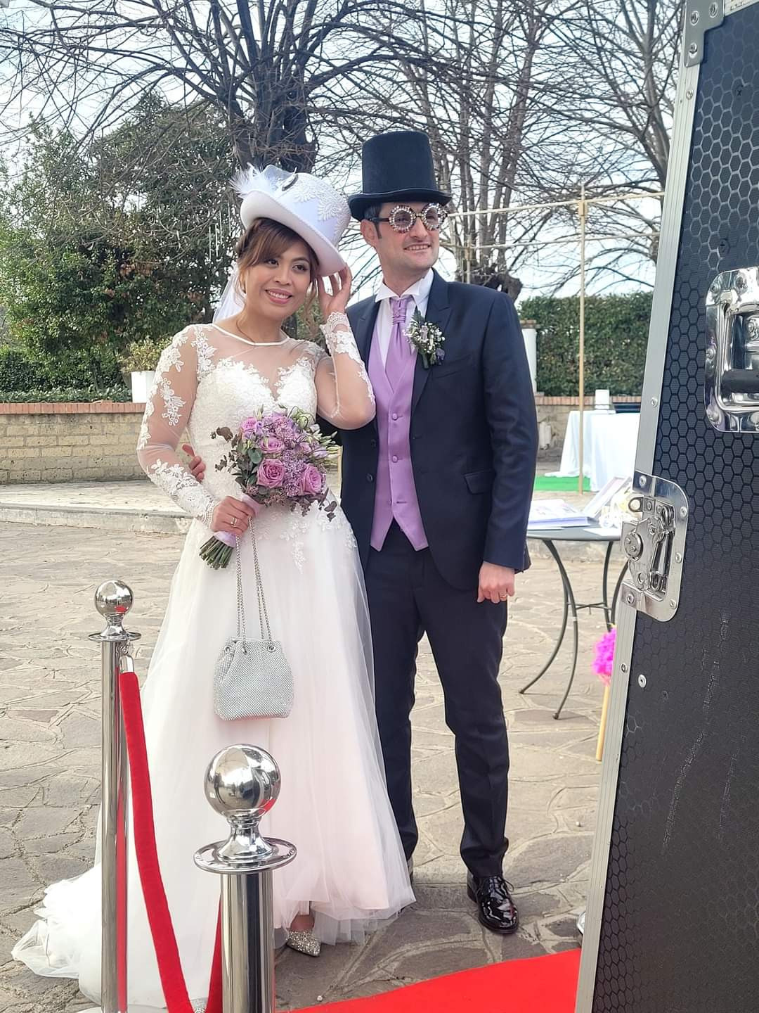 a bride with wedding makeup and hairstyle posing with her groom in a park in rome