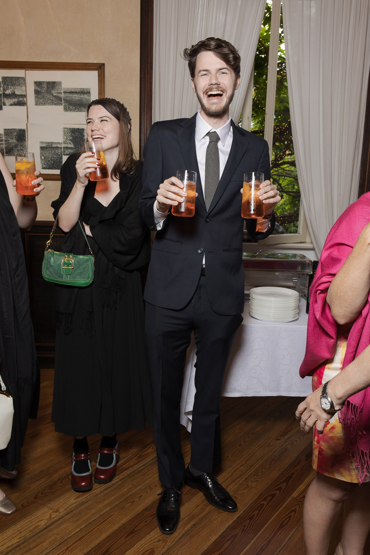 Authentic business networking and candid guest emotions at a corporate party in Milan, Italy.