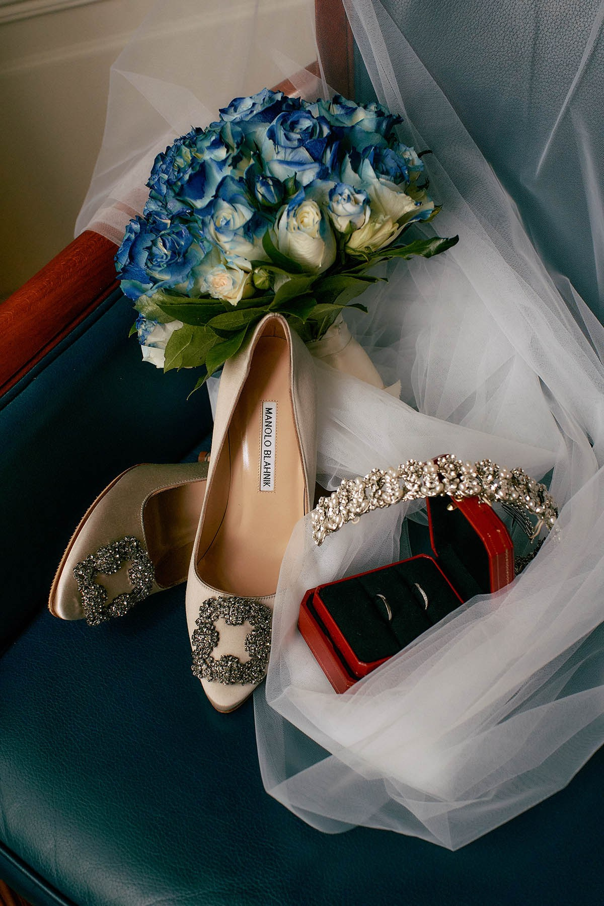 Manolo Blahnik shoes, bouquet, rings, and veil – await the bride's transformation.