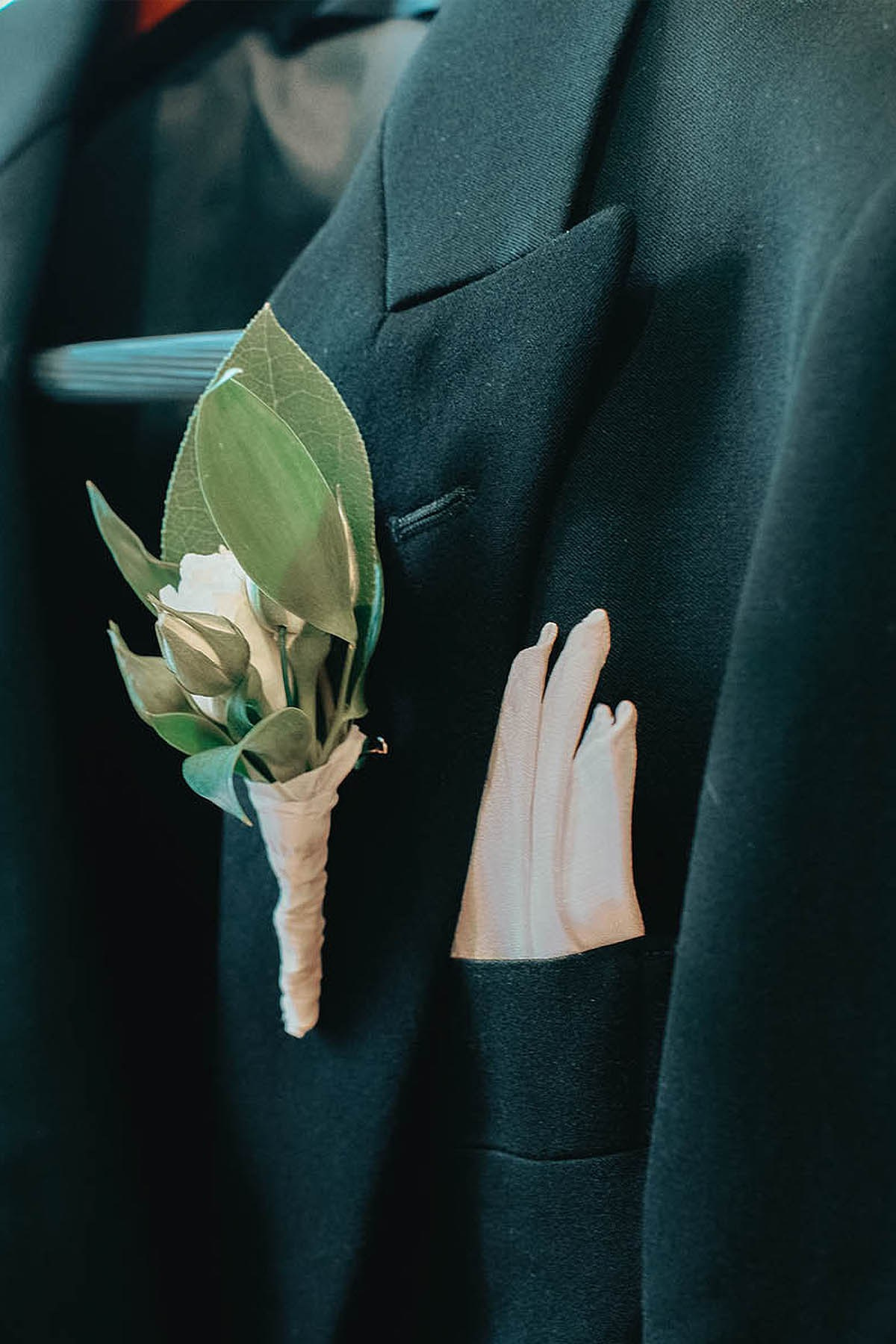 The groom's stylish suit and boutonniere.