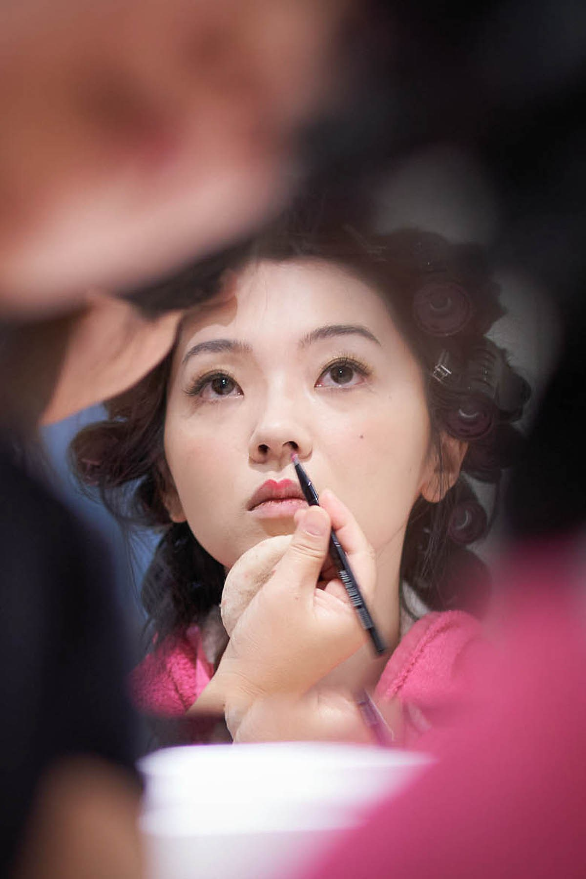 Bride Hitomi having makeup applied by Parisian artist in Palais Coburg suite.
