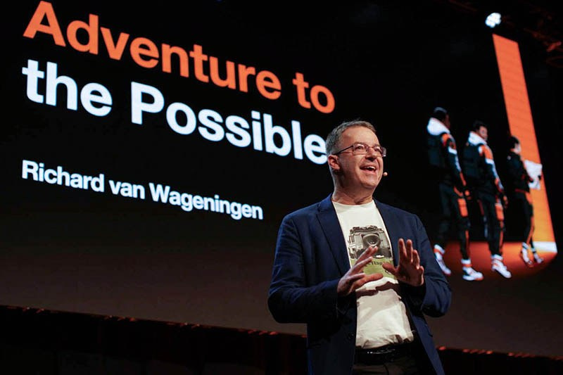 Richard van Wageningen, President Europe Orange Business, speaks on stage with 'Adventure to the Possible' backdrop at 2026 Sales Kick-Off, Hilton Prague.