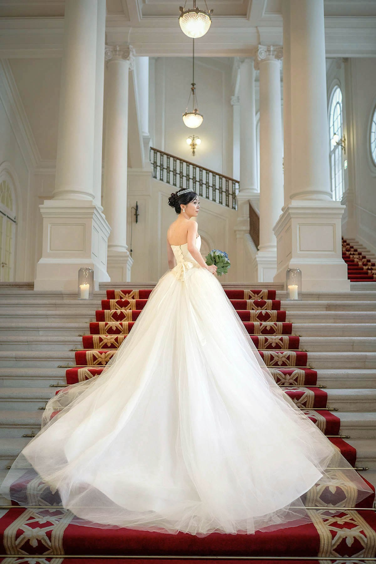 The bride and her bouquet pose for a photo inside the historical palace built between 1840 and 1845 as a grand city residence.