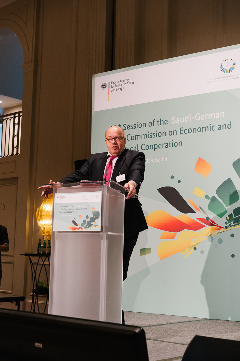 A speaker addresses the audience from the podium at a corporate forum in Berlin