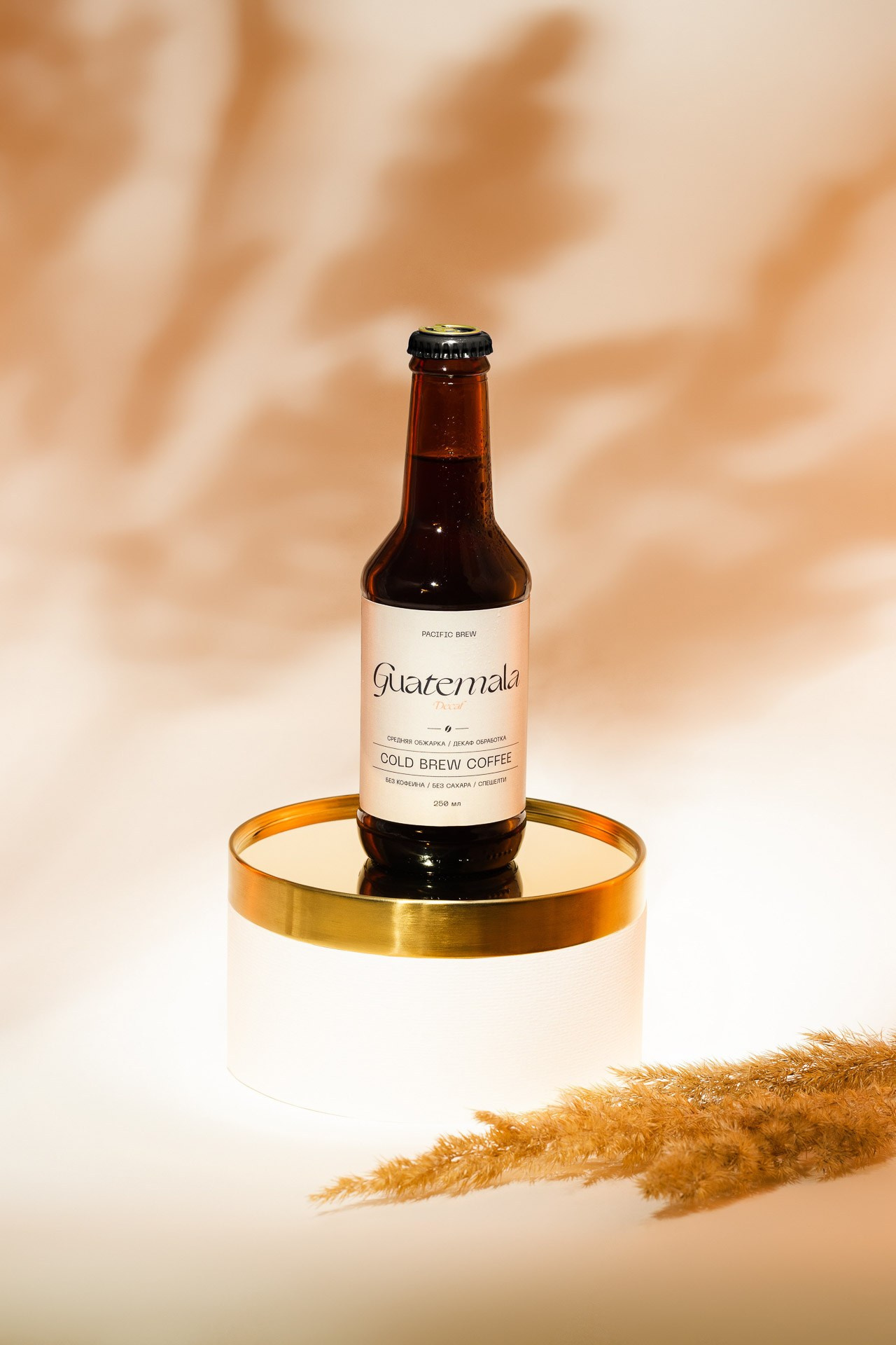 Product photography of bottled drink with glass, warm studio lighting