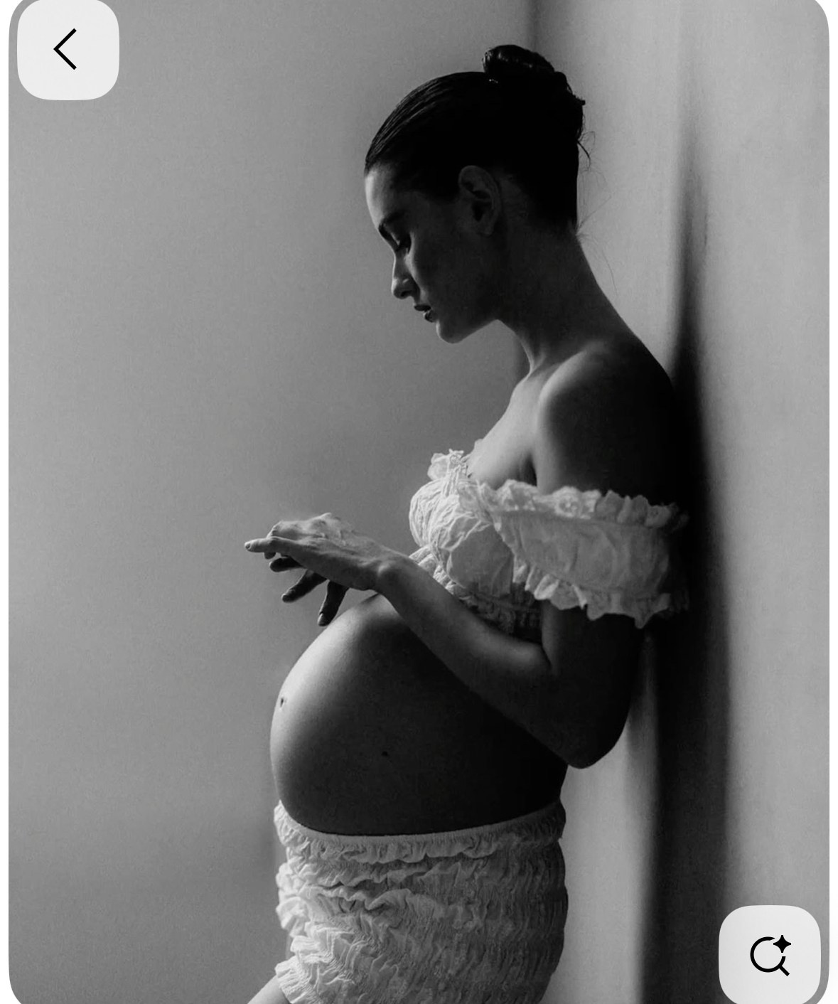 Lifestyle pregnancy photography on the couch with neutral bedding