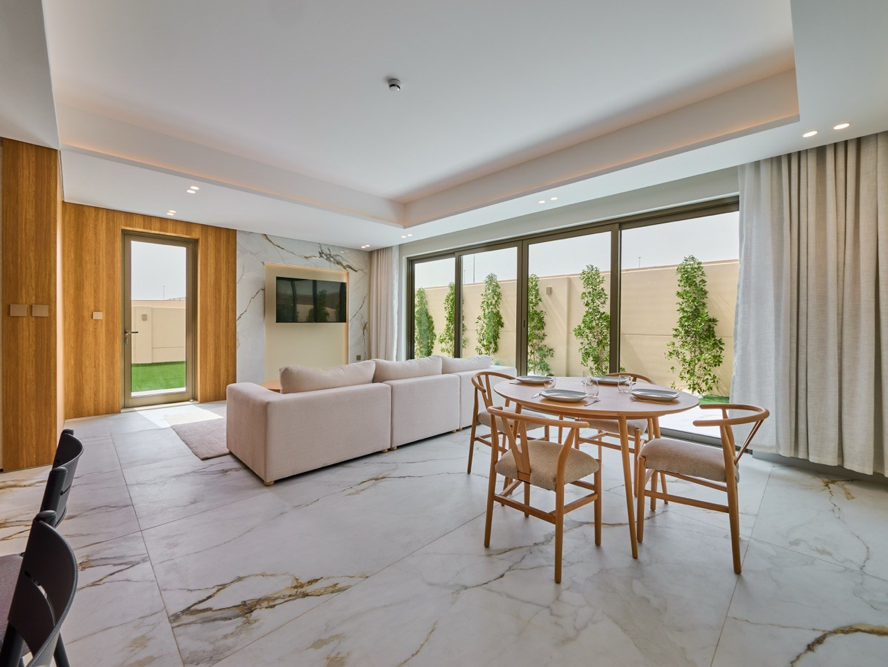 Natural-lit dining space with wooden furniture, by spaces photographer.
