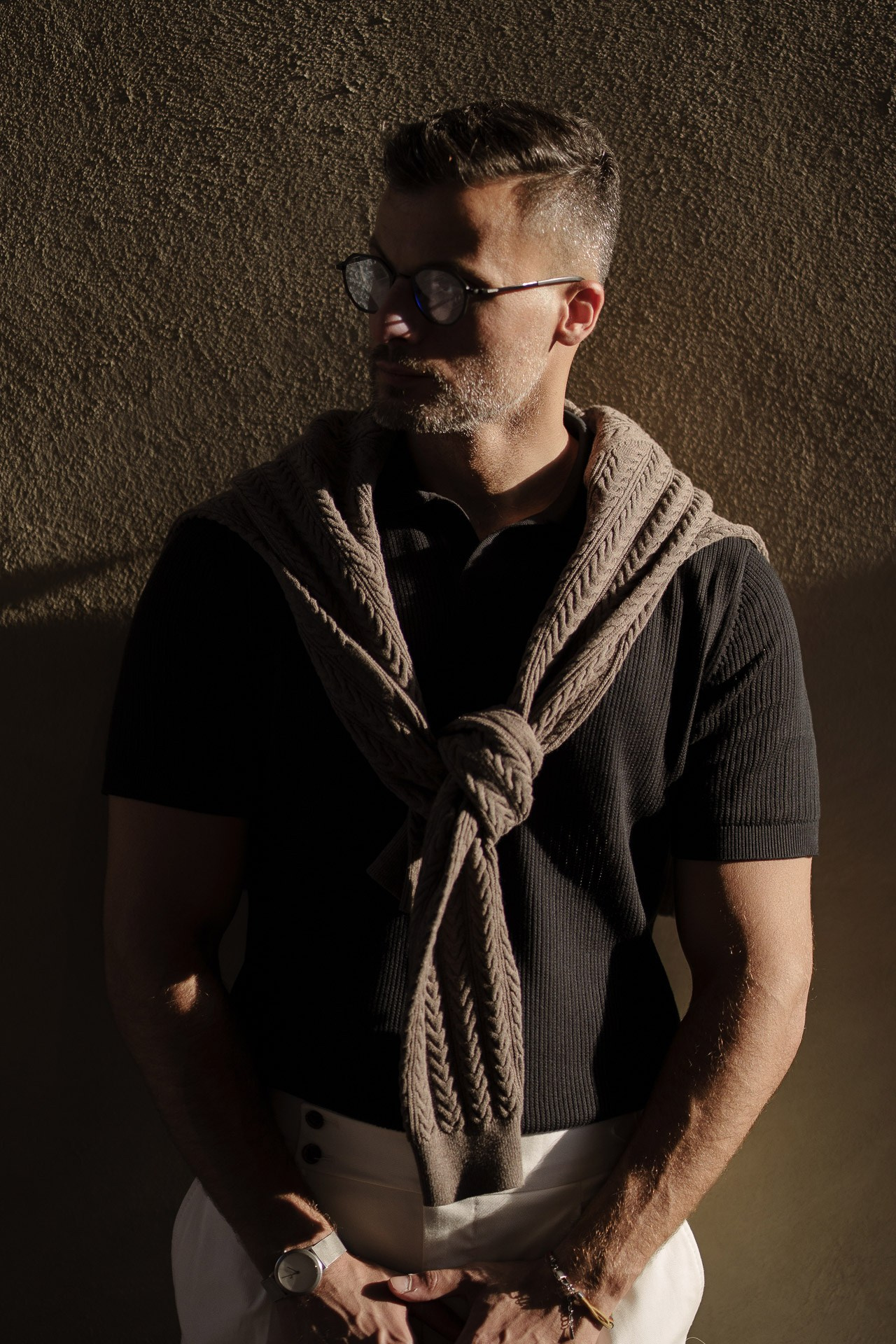 Dramatic sunlight portrait of Jamal against a textured wall in Milan