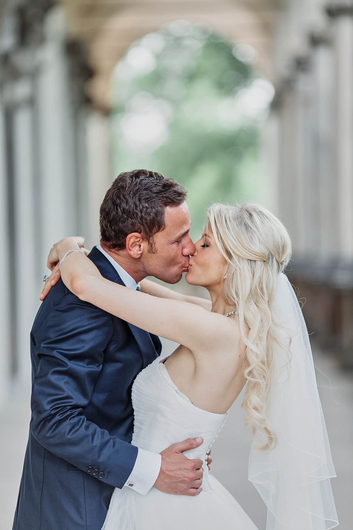 Passionate kiss between bride and groom at Queen Anne's Palace Prague
