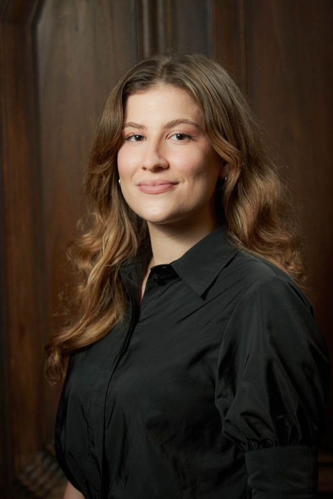 Corporate lawyer headshot in Prague office with wood panel background