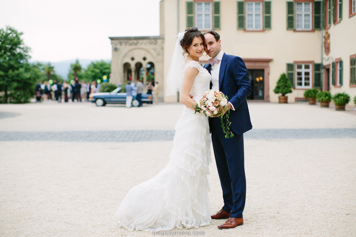 Wedding photography in wedding venue Schloss Bad Homburg, Frankfurt area. Couple is standing in the middle on historical square